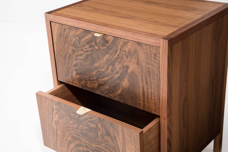 The Laska Nightstand is built in our Brooklyn studio using premium hardwoods and thoughtfully selected wood veneers. This piece features custom veneered panels framed flush with solid hardwood edges and legs. The two drawers showcase crotch-cut