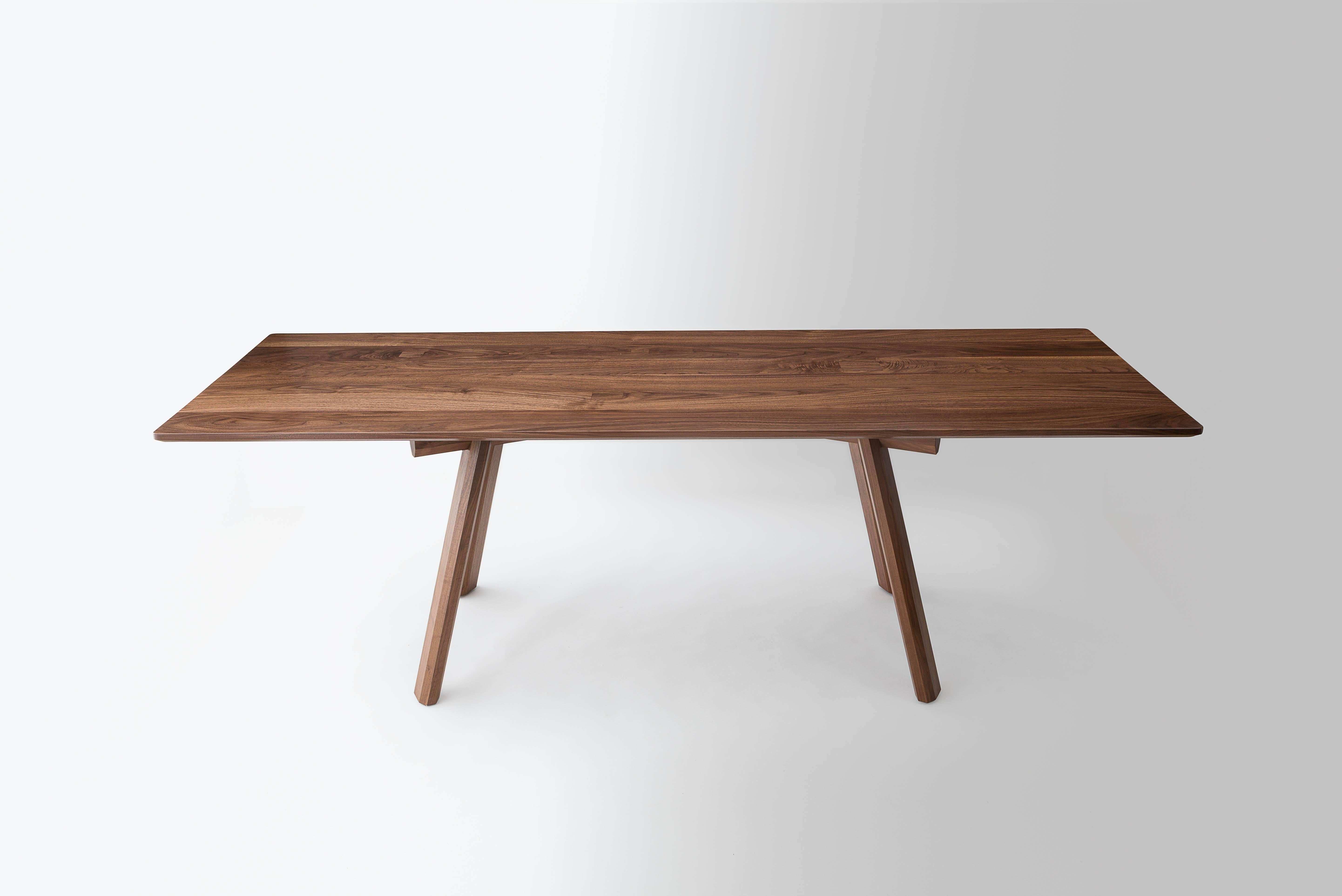 The Ripley dining table is built by hand on our Brooklyn Studio using premium hardwoods. The base is constructed with traditional joinery. The faceted legs help to showcase the exaggerated lap joints that give the table its robust feel and