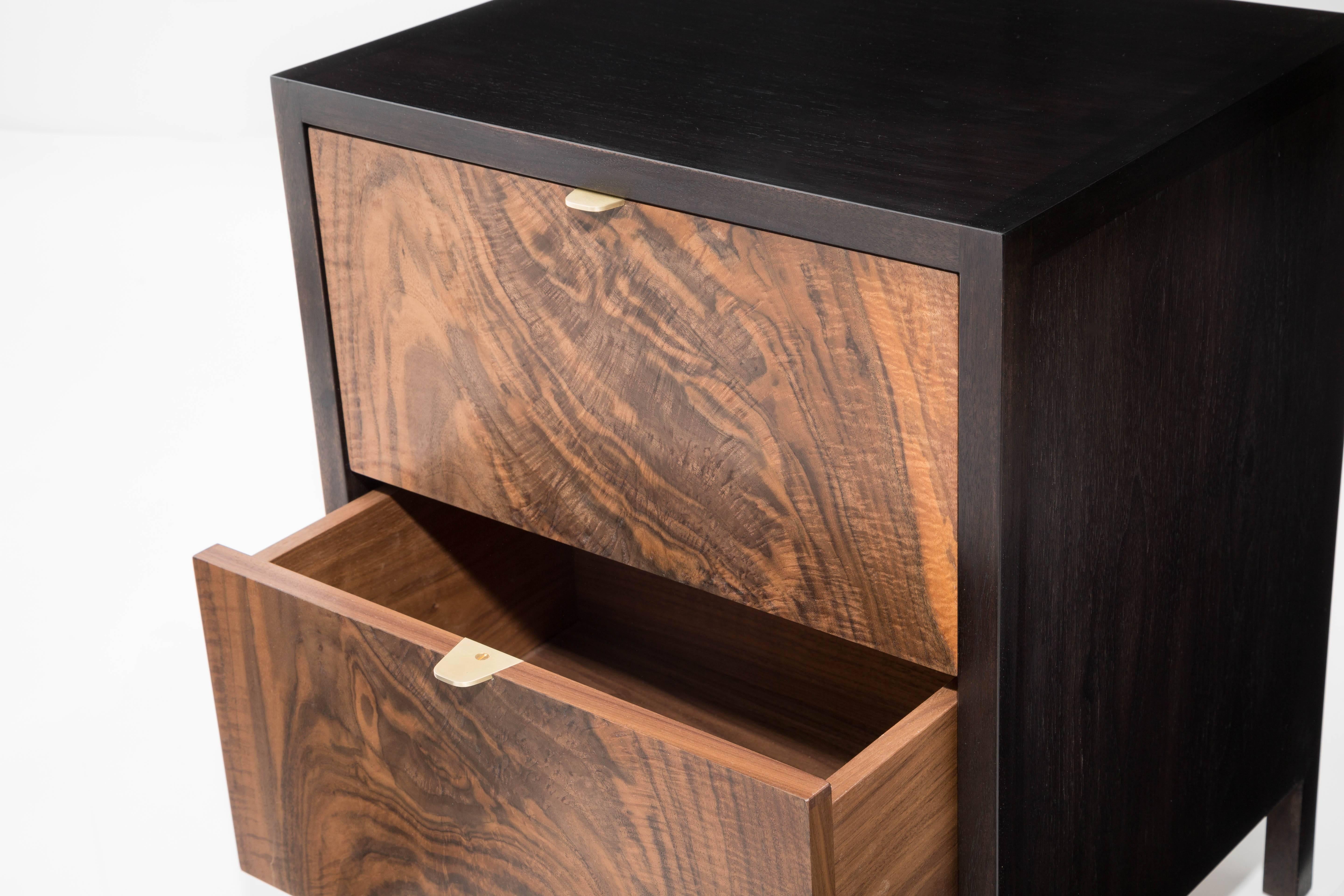 The Laska Nightstand is built in our Brooklyn studio using premium hardwoods and thoughtfully selected wood veneers. This piece features custom veneered panels framed flush with solid hardwood edges and legs. The two drawers showcase crotch-cut