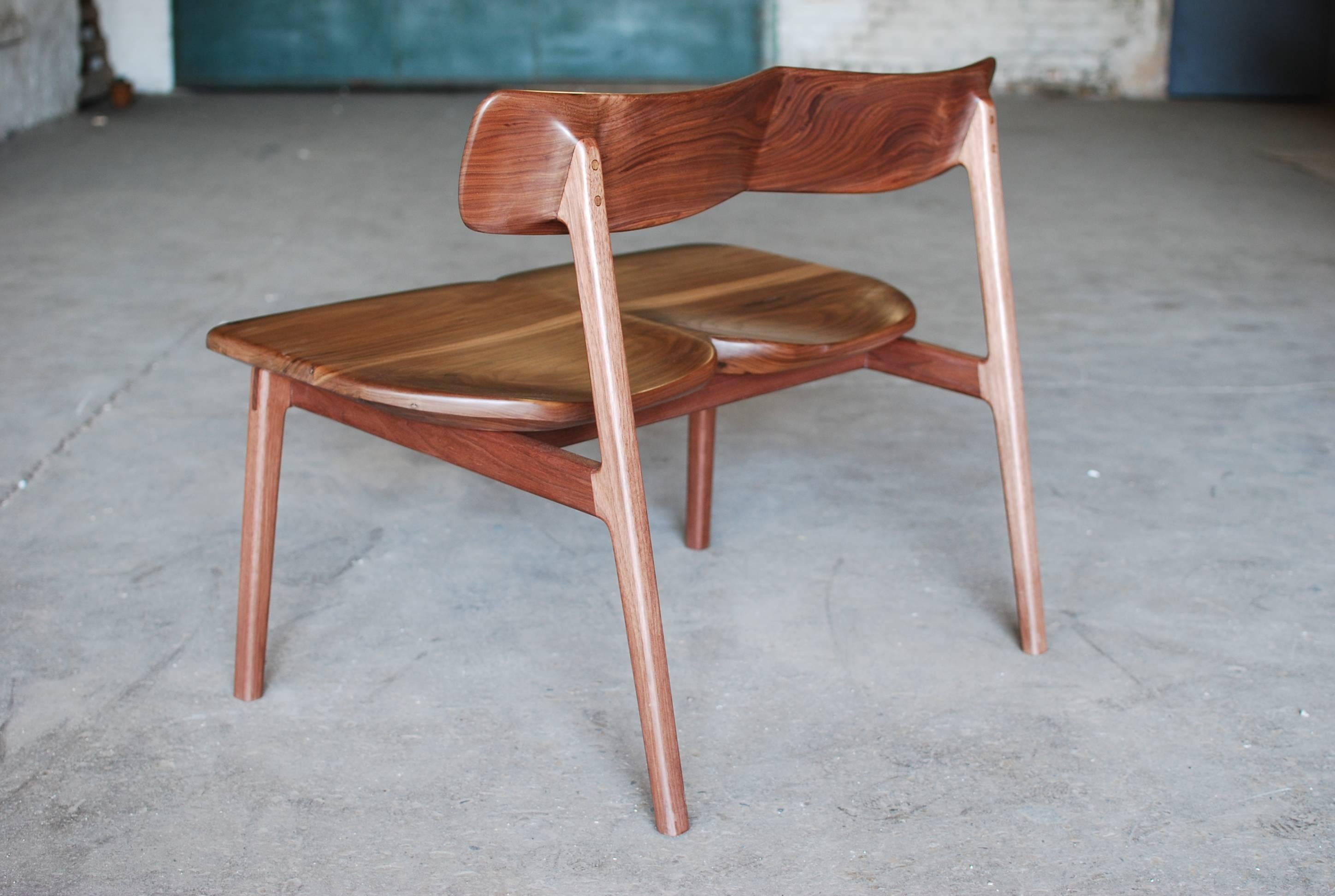 The C01 bench is a two-seat version of our C01 chair. The double seat and back are shaped together in the center and sculpted at the legs, giving this bench a dramatic presence. 

Handmade to order in our Chicago studio. Shown in black walnut with