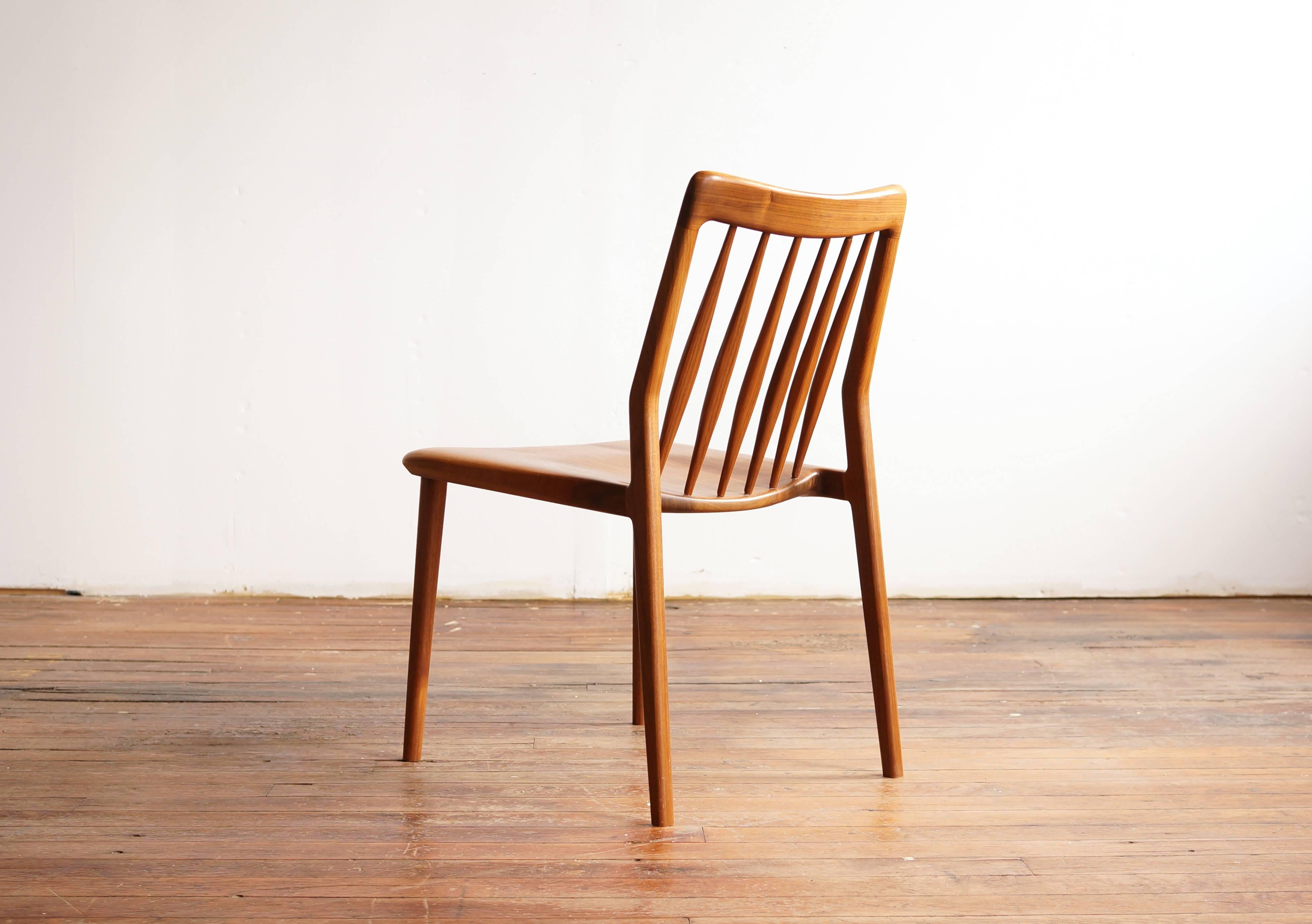 The C04 dining chair, in solid American black walnut. The design references Windsor chair tradition - with the hand scooped seat and the back rest of carefully shaped and angled spindles - but taken in a more modern, organic direction. 

Handmade to