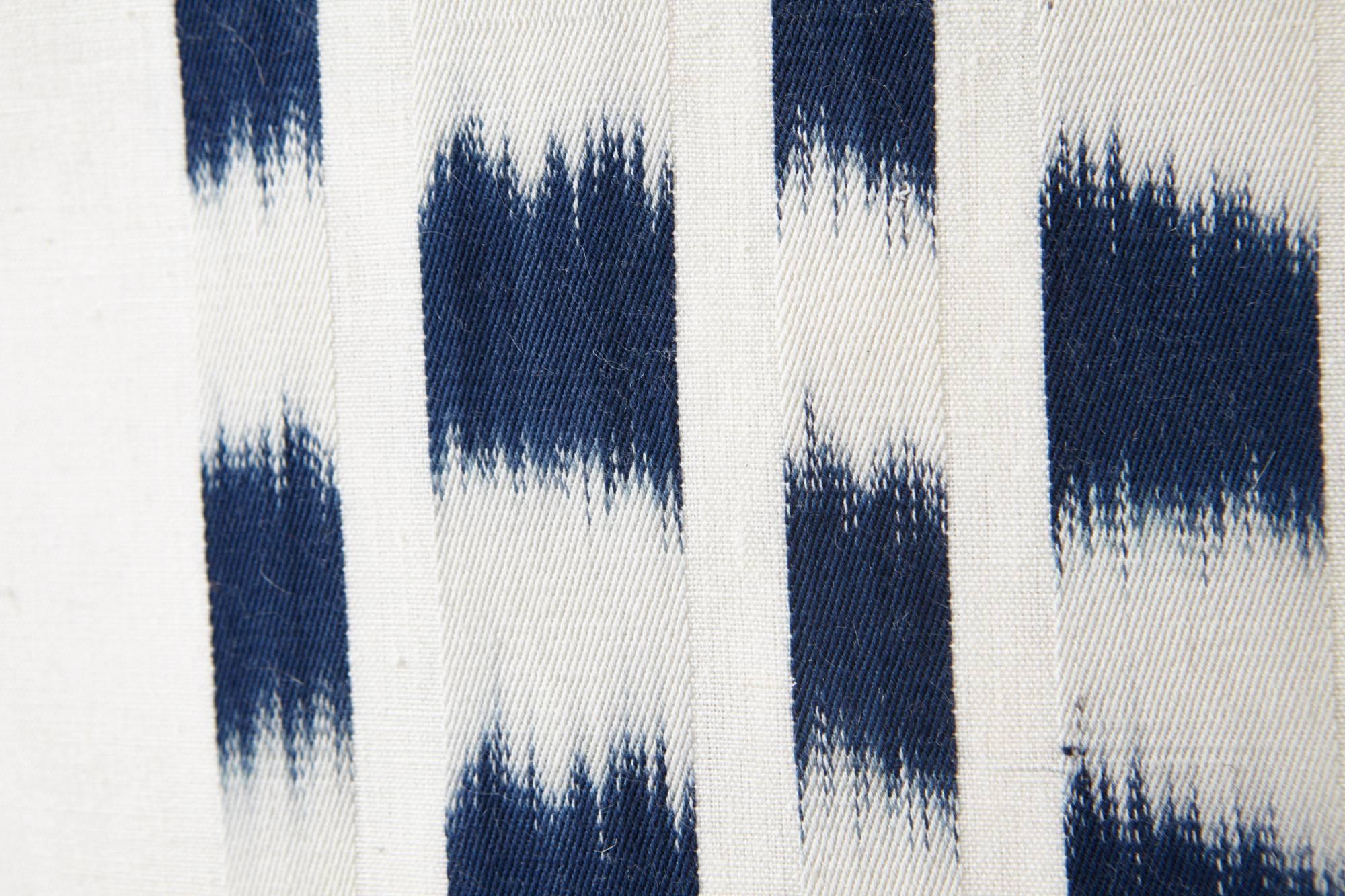 Using a traditional, artisanal weaving technique, this Schumacher Izmir Stripe Ikat is intentionally irregular, emphasizing the art of the hand. Subtle variations are part of its inherent beauty. Featured as an oversized decorative accent, this is