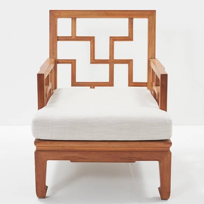 A pair of stunning Mid-Century Modern wooden teak club chairs featuring a unique Chinese Chippendale geometric detail.  In architecture, Chinese Chippendale refers to a specific kind of railing or balustrade that was inspired by the 