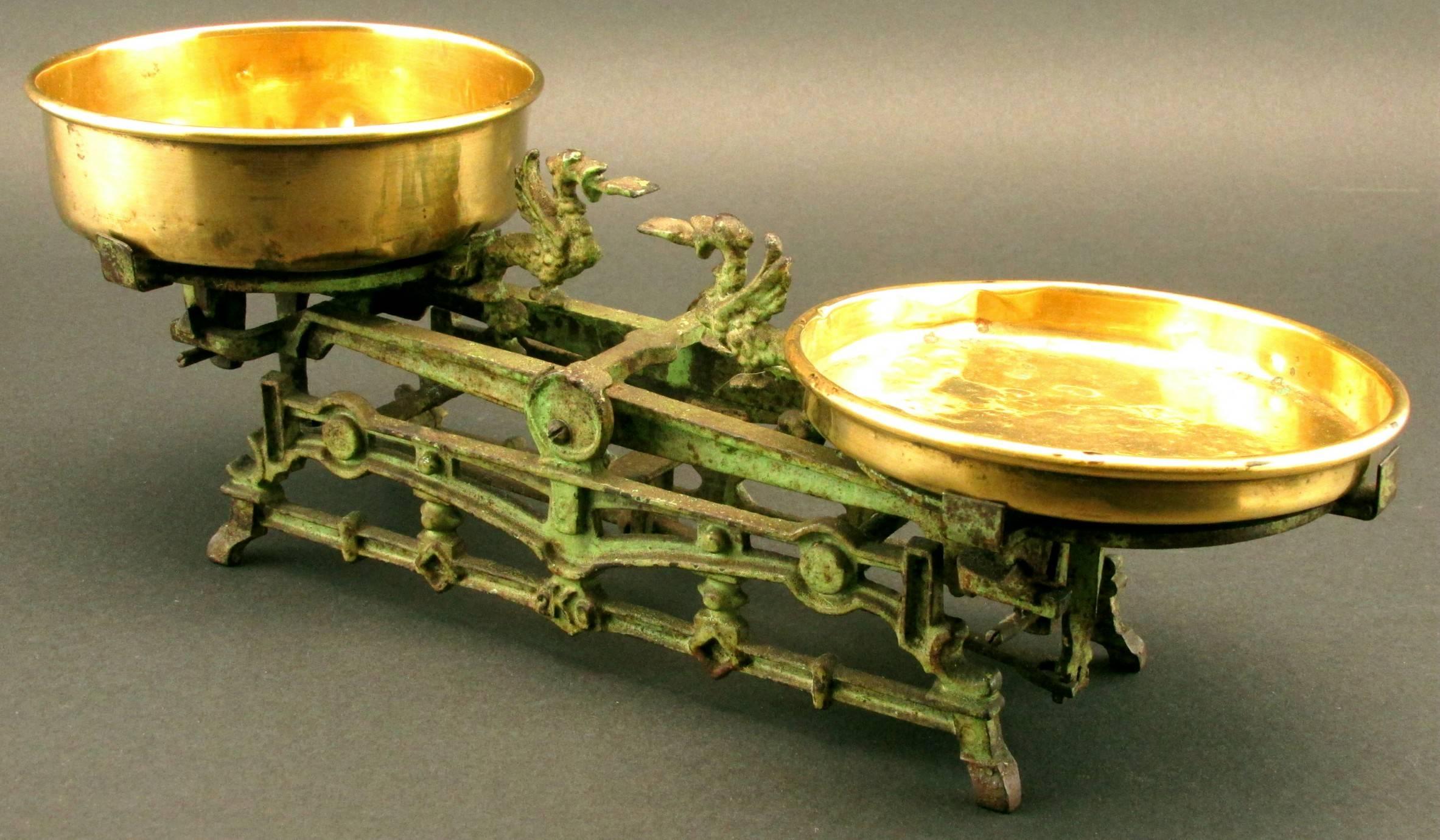 A very charming accent piece in original green paint and retaining both original brass weigh pans.