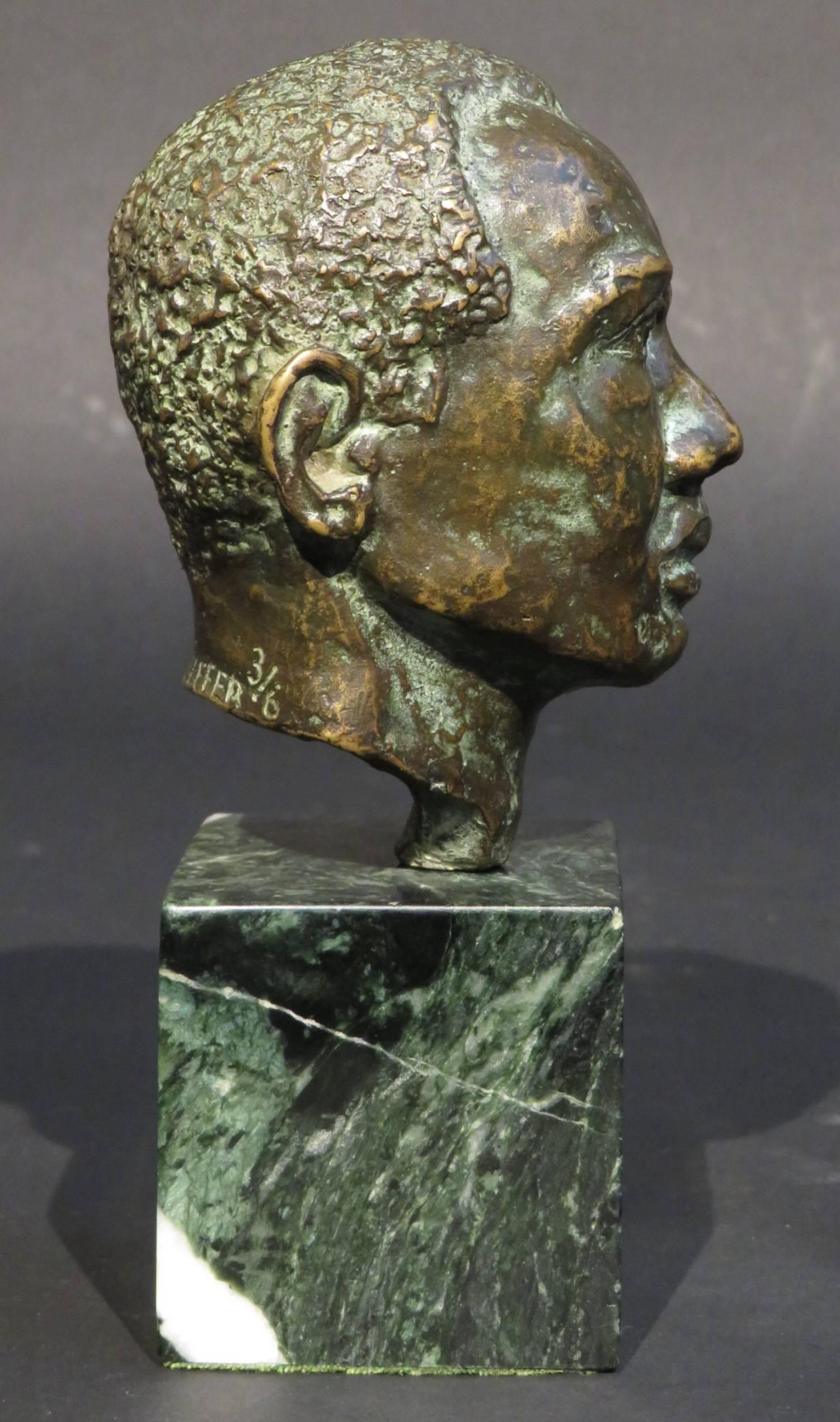 A finely sculpted limited edition miniature bronze bust of a Bahamian man exhibiting a fine brown/green patina overall, signed & numbered on the reverse H. Pfeiffer 3/6, raised upon a striated green marble base. 
Harold Sampson Pfeiffer (1908-1997)