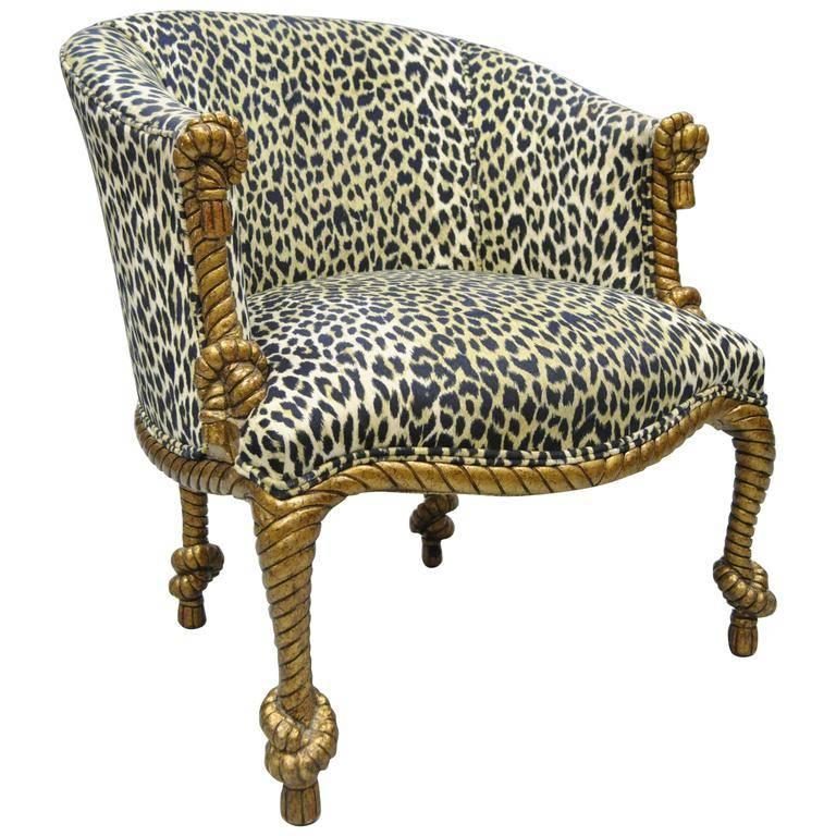 Napoleon III style rope and tassel carved chair and ottoman made in Italy. Item features a solid carved wood barrel back frame, gold finish. Upholstered in leopard print, this seat is perched atop hearty knots of rope and evokes the true definition