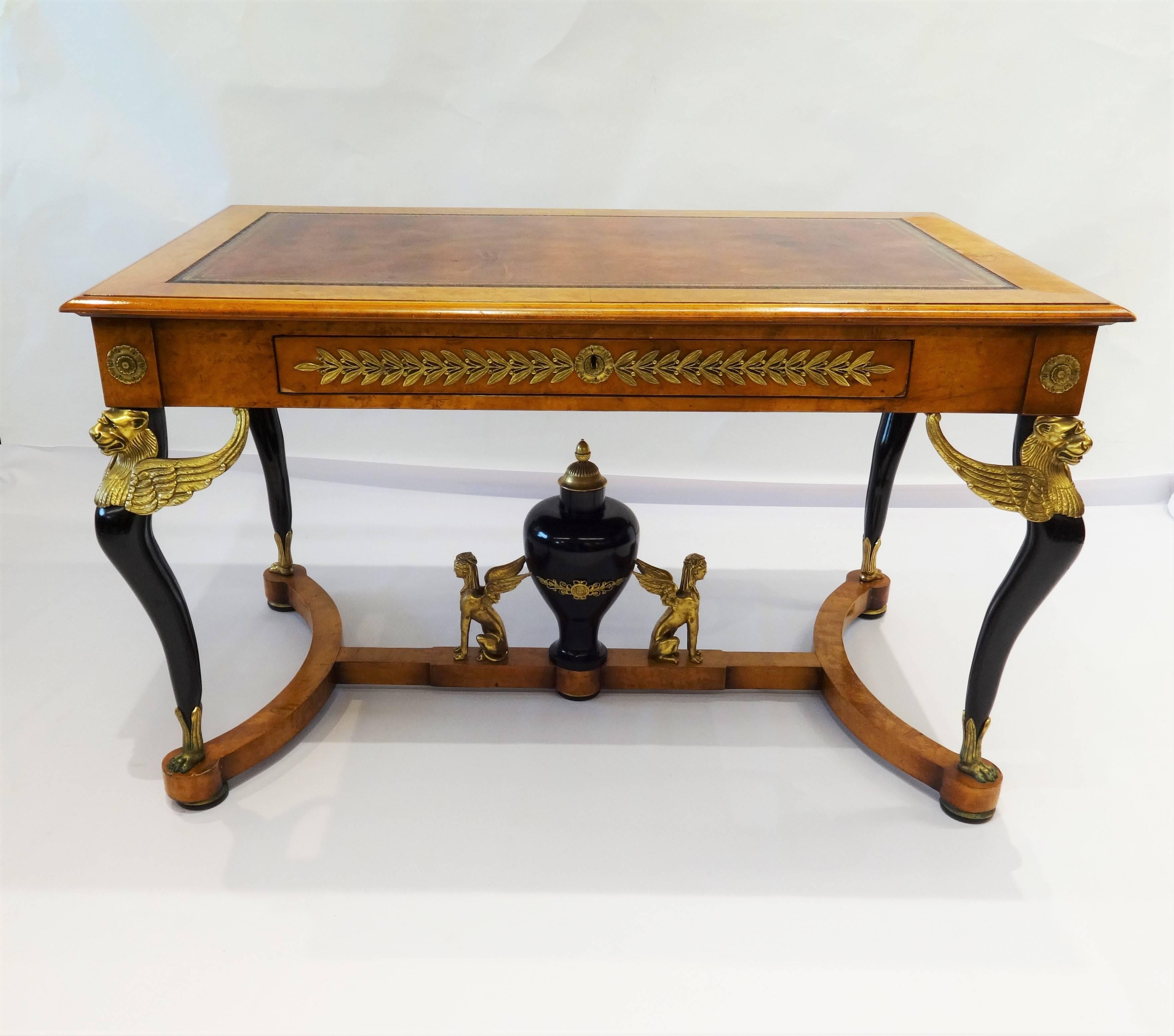 Masterful craftsmanship an illustrious example of 19th Century French furniture making at its finest. Extravagant combinations of materials, this desk is certainly no exception. Burl wood table with one drawer, bronze trim and winged griffins on