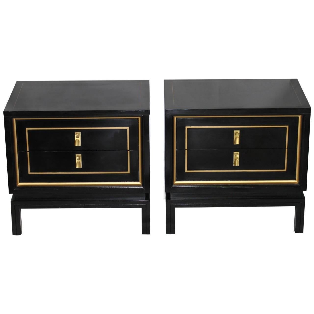 Pair of black lacquered and gold painted detailing night stands or end tables by American of Martinsville. The Dorothy Draper inspired nightstands have attractive brass pulls and two pull-out drawers.