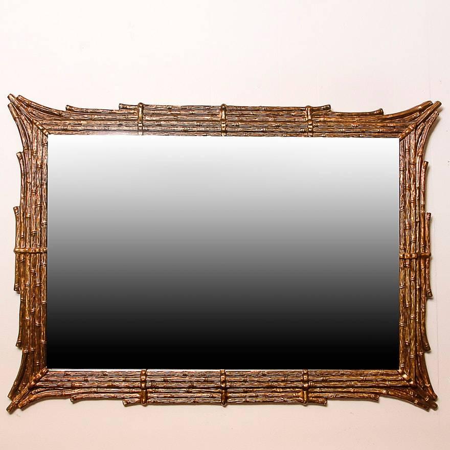 Glamorous Hollywood Regency style faux bamboo wall mirror, circa 1960s-1970s.