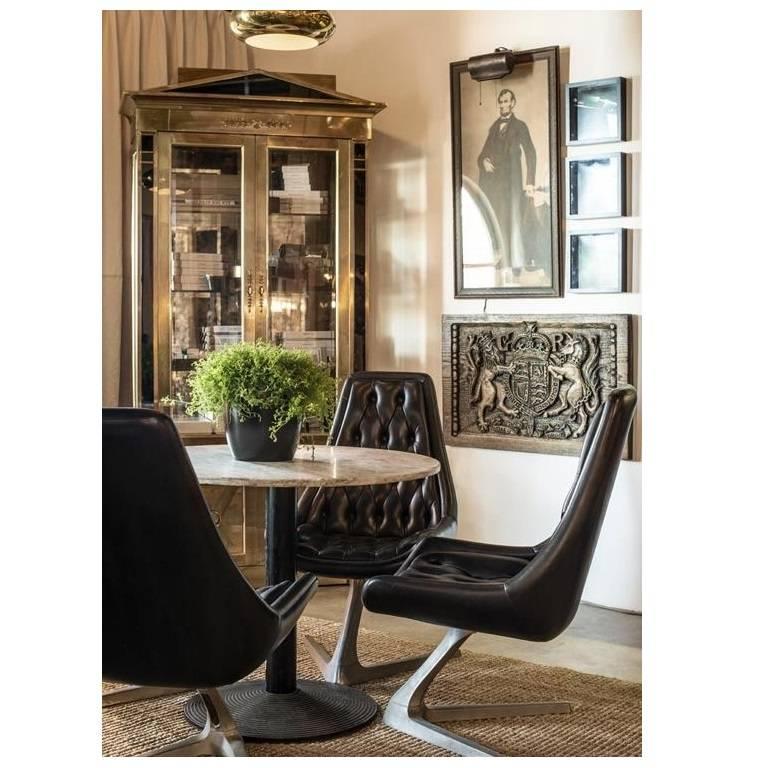 Empire style cabinets with black glass pediment and columns flanking the upper and lower doors, and fine brass handles and mounts, 1970's. Antiqued smoked mirror back and grooved glass shelves for plated. Beveled glass doors and side panels.