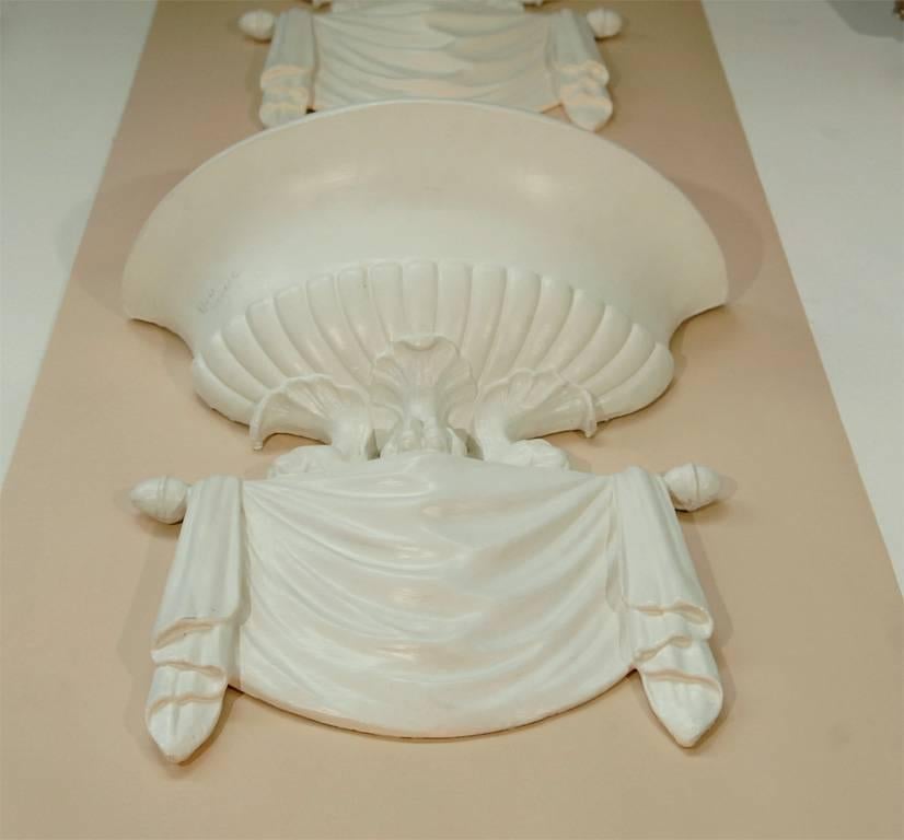 These sconces are fabricated in plaster. In the modern neoclassical style, ornamentation that is both Classic and surreal. Very much in the style of pieces created by Dorothy Draper and date from the 1940s, they will make a definite statement in