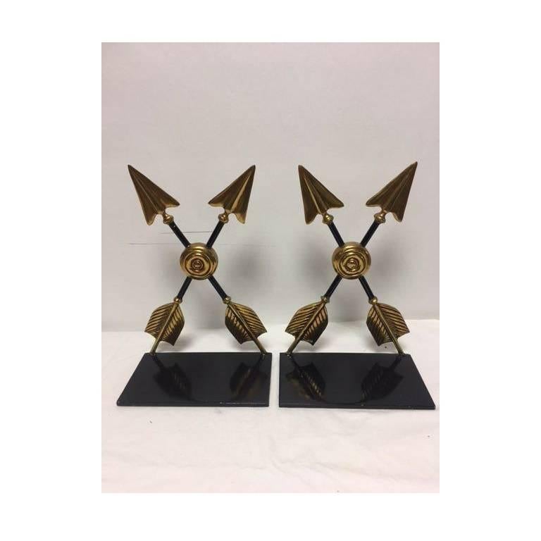 Regal brass cross arrow bookends from Maitland-Smith. 
Brass and black base.