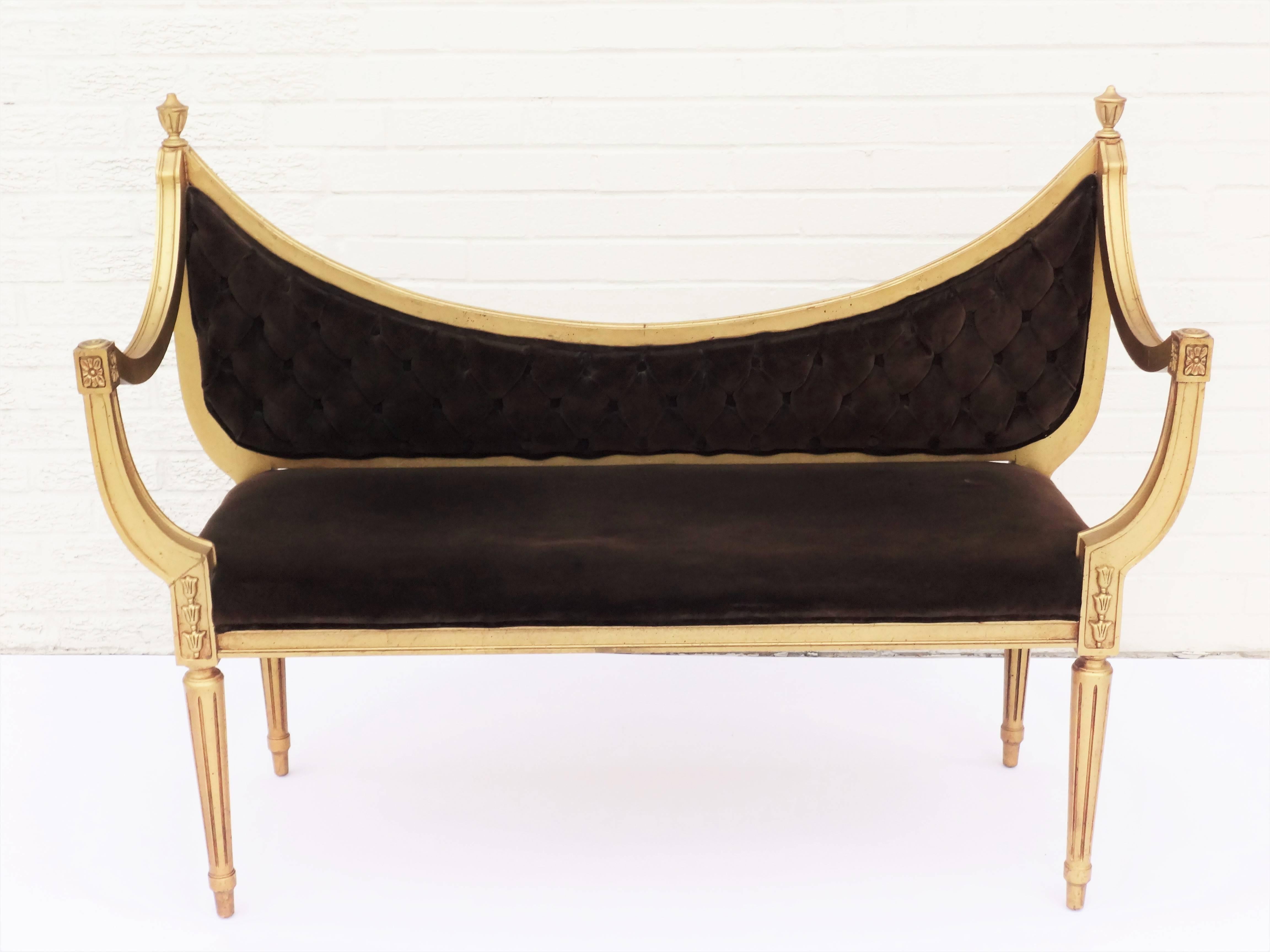 Hollywood Regency tufted scoop back settee bench with reeded legs and wonderfully shaped arms, gilt ball finials and detailing. All original gold finish and fabric. Ready to be reinvented with your choice of fabric and finish. We offer the finest