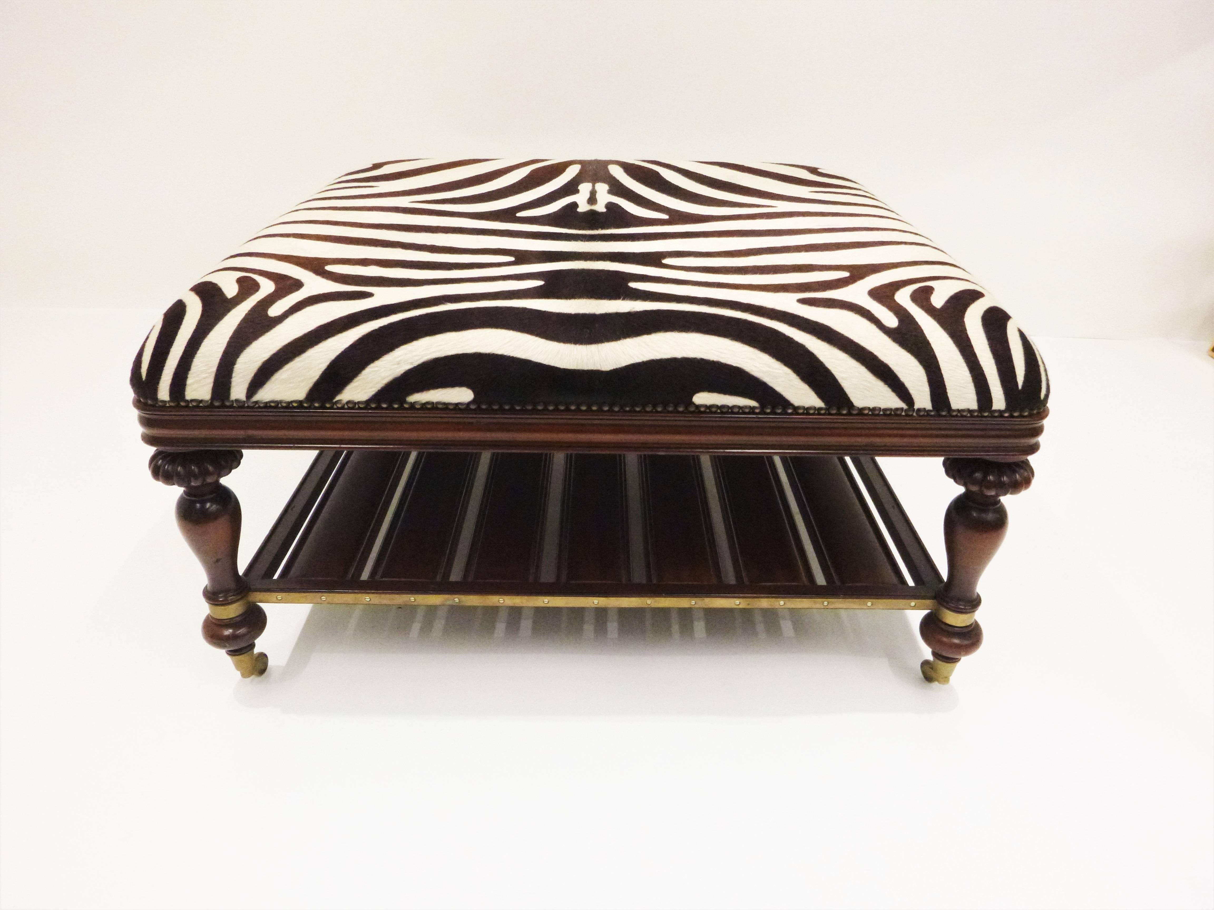 Classic design vintage zebra hide open style coffee or cocktail table. Mahogany framed, zebra hide trimmed in nailhead around all edges. The studding is achieved with close individual studs, each nail is individually hammered in by hand. Brass