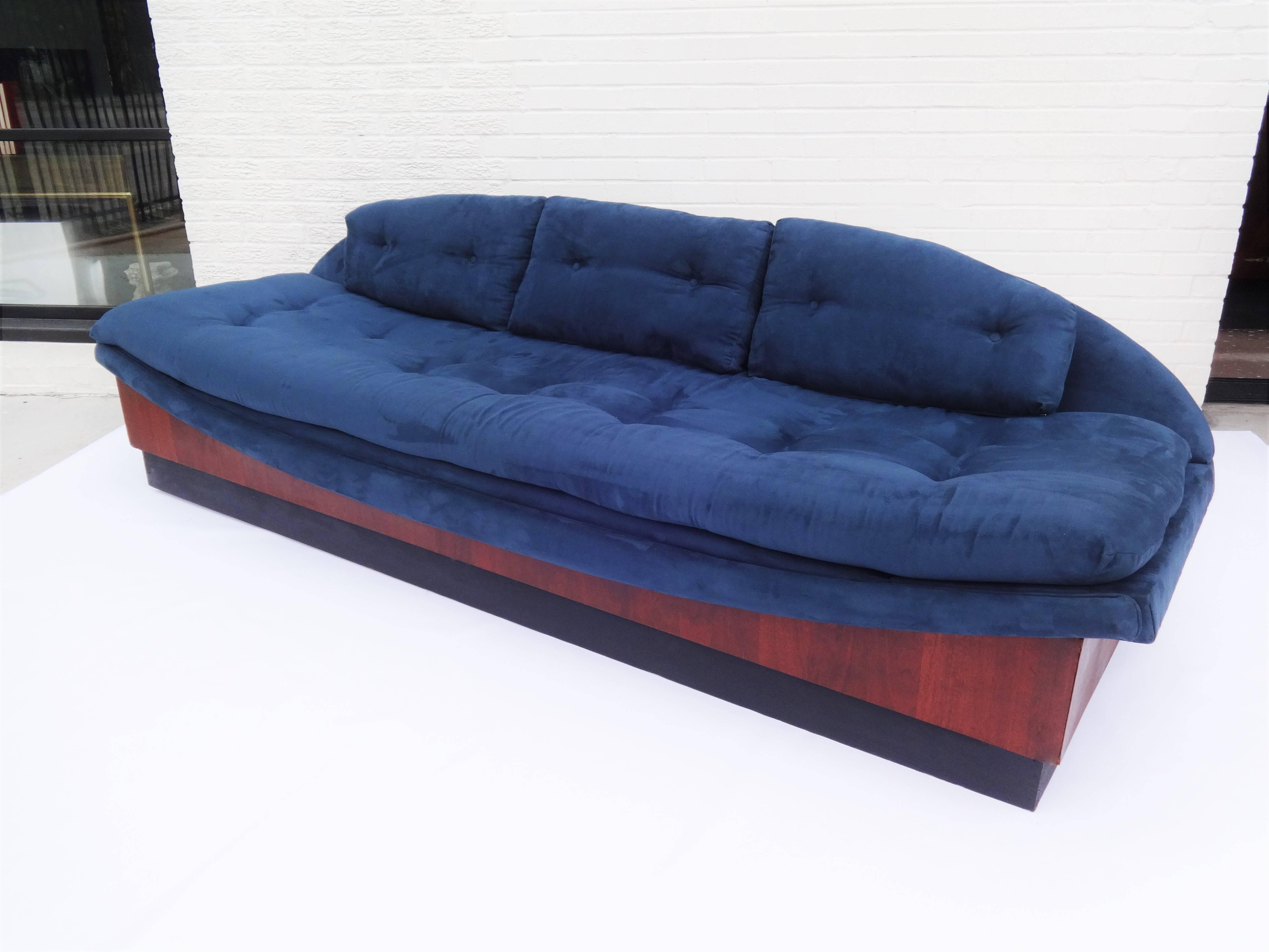 Vintage sculptural Gondola sofa designed by Adrian Pearsall for Craft Associates USA, circa 1965. The sofa floats above a matte black recessed platform and a 9.25 inch strip of walnut wood. Upholstered in blue fabric.
 