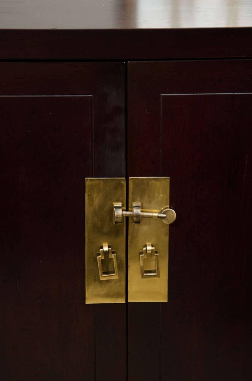 Pair of Asian inspired cabinets by Henredon as part of their Artefacts collection. Simplistic in design, it features Asian style brass latch and door hinges. Two doors that open up to a full width with pull-out drawer and an adjustable shelf. These