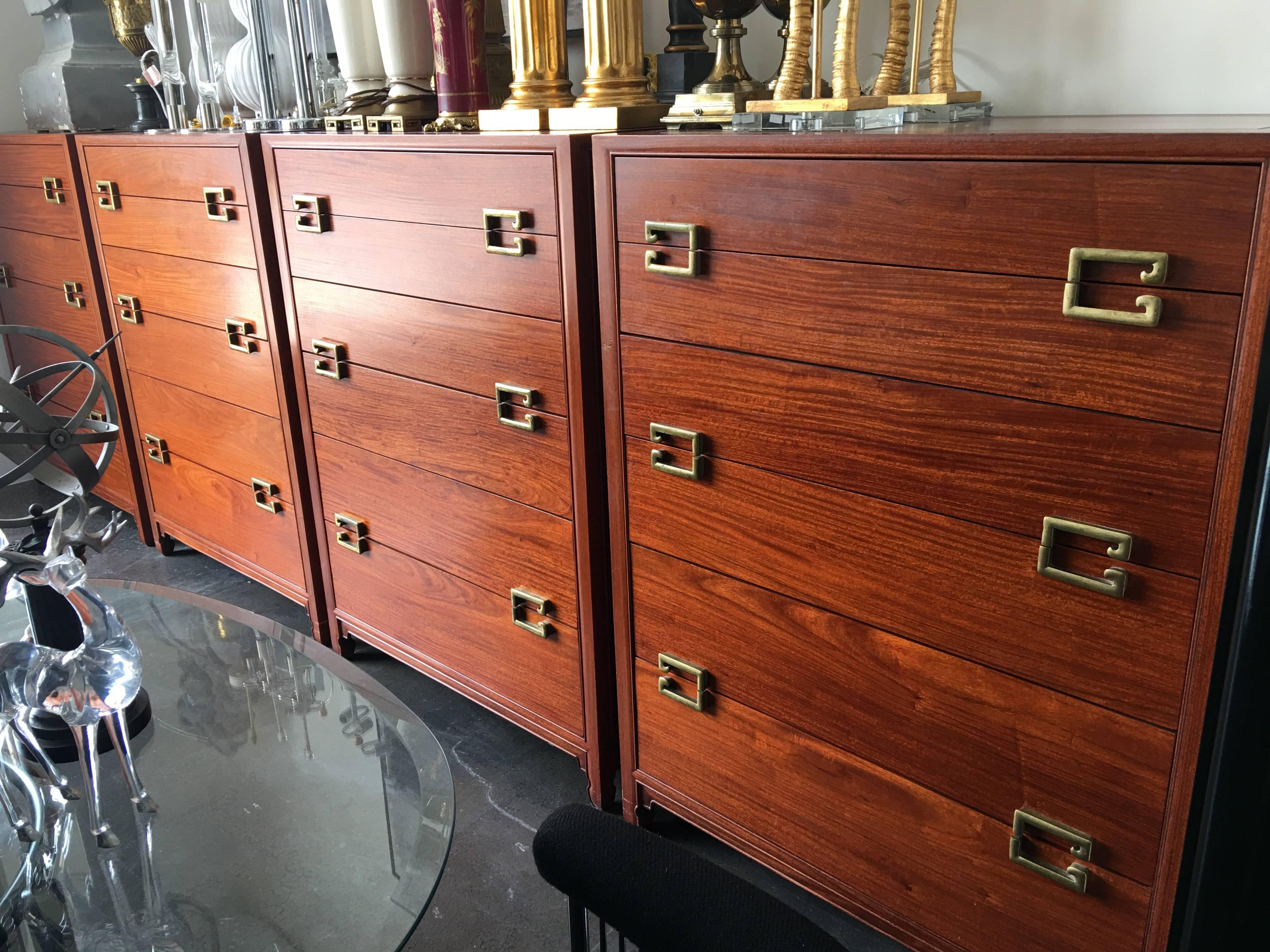 A fine 1940s Paul Frankl style Asian Inspired rosewood six-drawer tall dressers with solid brass hardware providing great storage. Artfully manufactured.