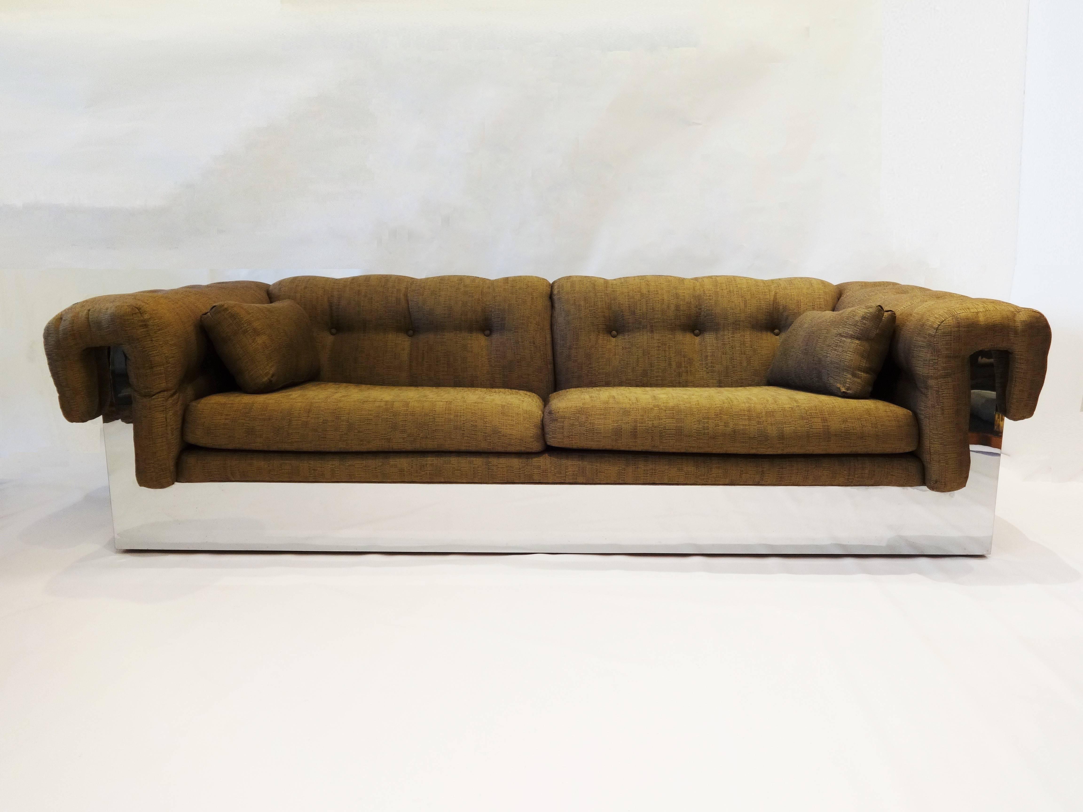 1970s modern sofa designed in the style of Milo Baughman and made by Thayer Coggin. Chrome wraps entire base and forms support for the button tufted arms and back with original upholstery.