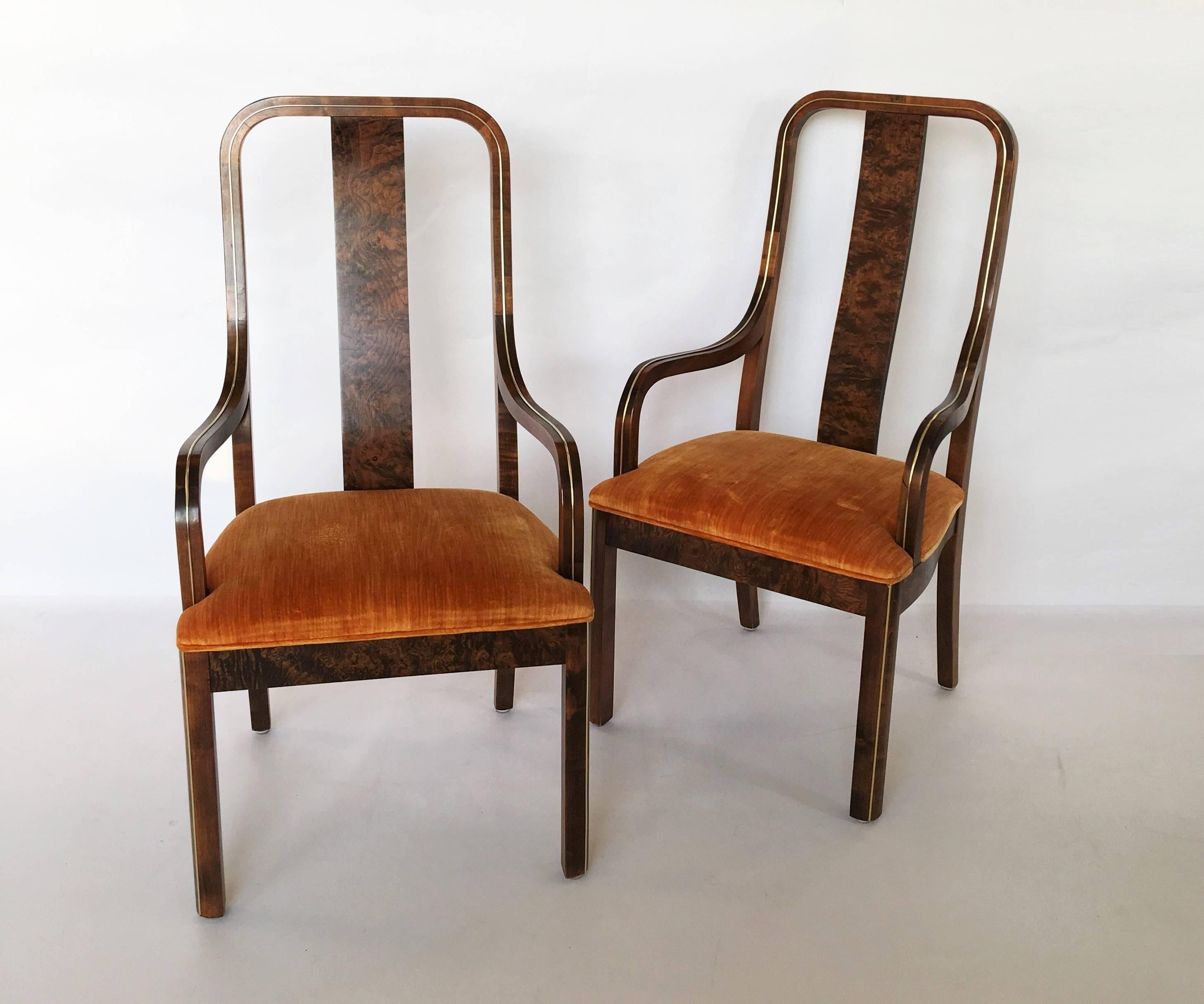 Set of six dining chairs by Century Furniture Company. The chairs feature stunning burled wood, with exquisite brass inlay and original orange velvet upholstery. Comes with two-arm chairs, four-arm less chairs. Retains original tags. 

Also
