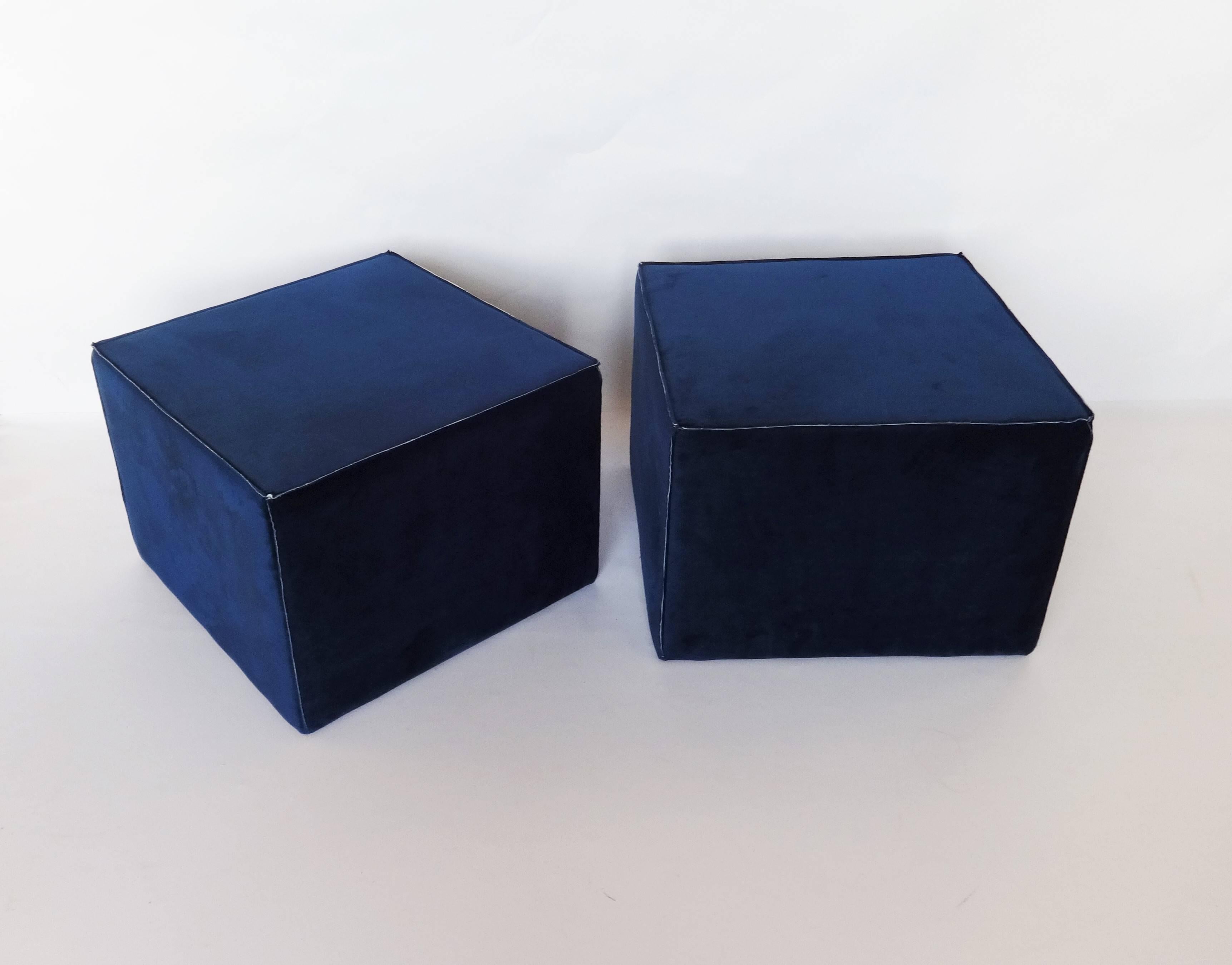 Pair of large modern upholstered ottomans. Beautiful edge detail. Navy colored velvet upholstery. Together, they provide super flexible seating, and double as a coffee table. New fabric and upholstery materials.