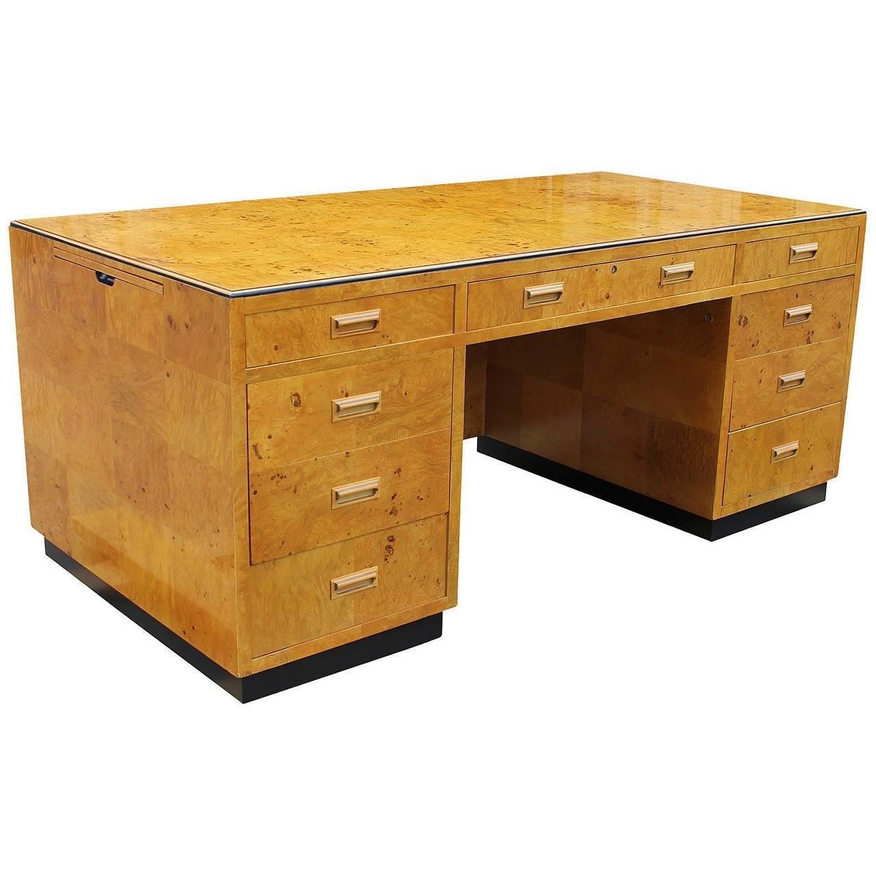 Beautiful burl wood executive desk with glass top by Henredon, series II. Exceptional solid construction, desk is veneered in blonde burl wood atop a plinth base finished in black lacquer. It has three pull-out writing surfaces: one on the right,