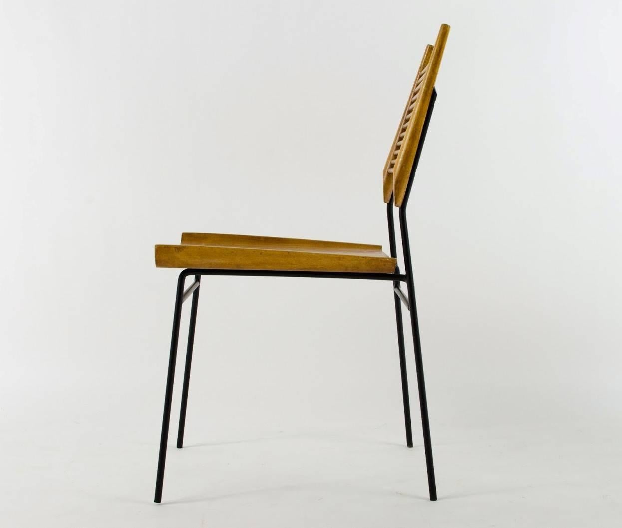 Famous chair designed by Paul McCobb. Blonde birchwood on a Minimalist wrought iron frame. Known as the 'Shovel Chair' for the sculpted shovel like seat. Thin dowel slat backrest.