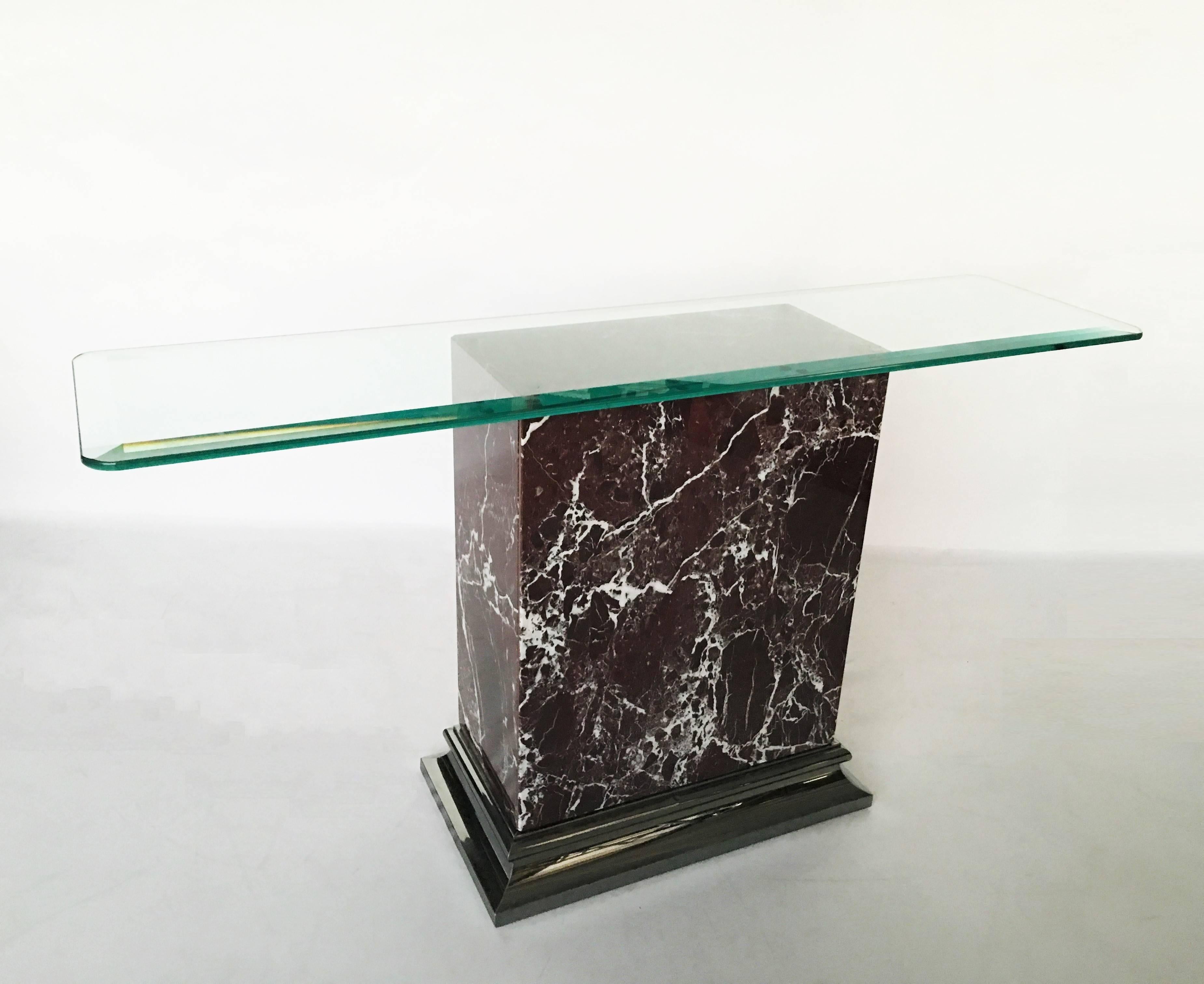 Vintage-modern console featuring Italian marble body with beautifully sculpted nickel trim with beveled glass top. Signed on the inside Made in Italy.

Measures with glass top: 29 in. H x 54 in. W x 14 in. D
Measures without glass top: 28.5 in. H