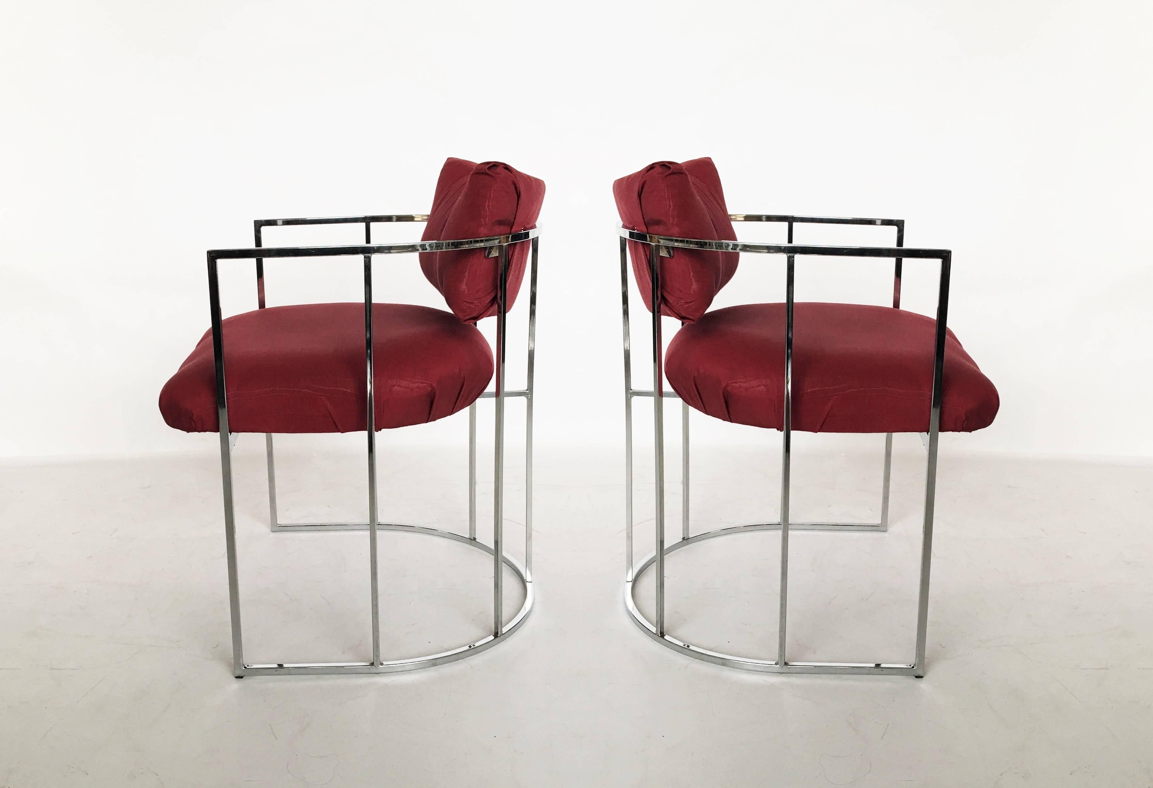 Four chrome Milo Baughman dining chairs for Thayer Coggin. Feature unique ellipse chrome frames with thick padded seating and a tufted floating backrest. Chrome is excellent. Upholstery is recommended.