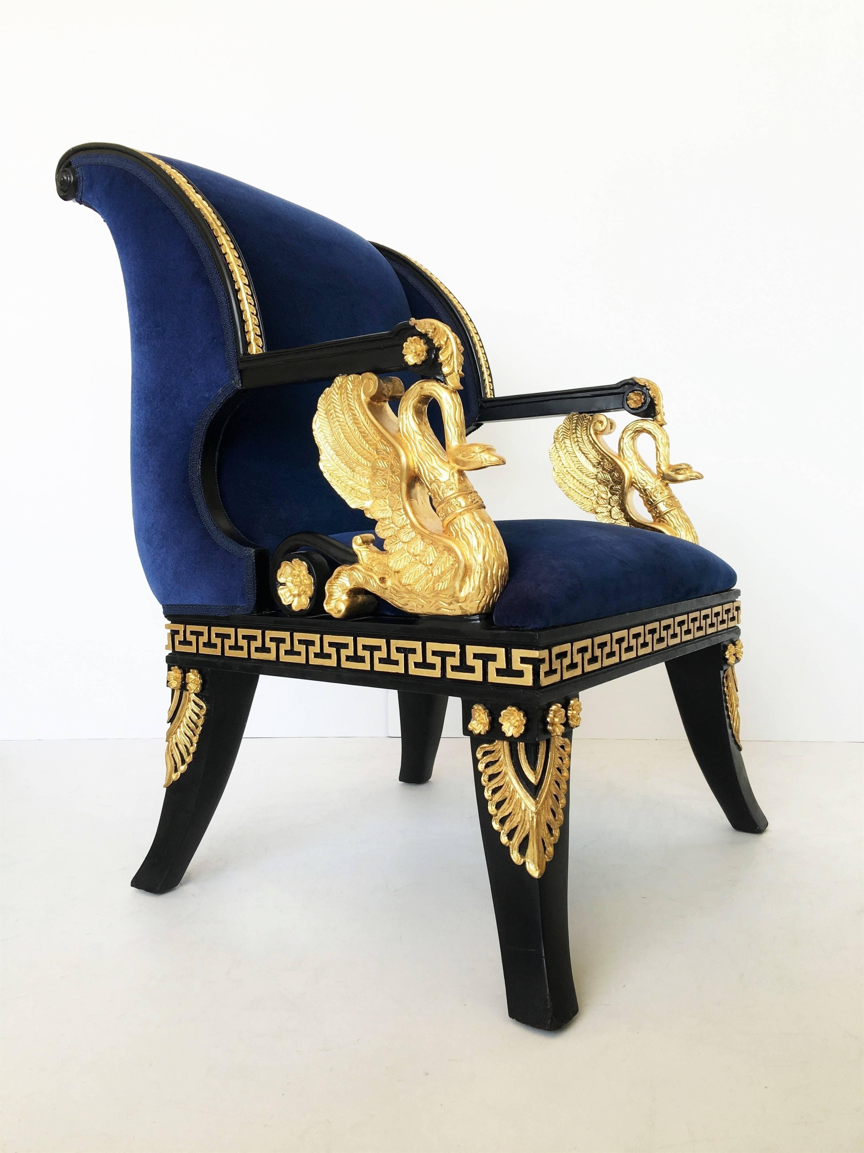 Neoclassic pair of lacquered and gilt carved wooden armrests raised on swan-shaped supports, the seat carved with rosettes and anthemion, raised on sabre legs.