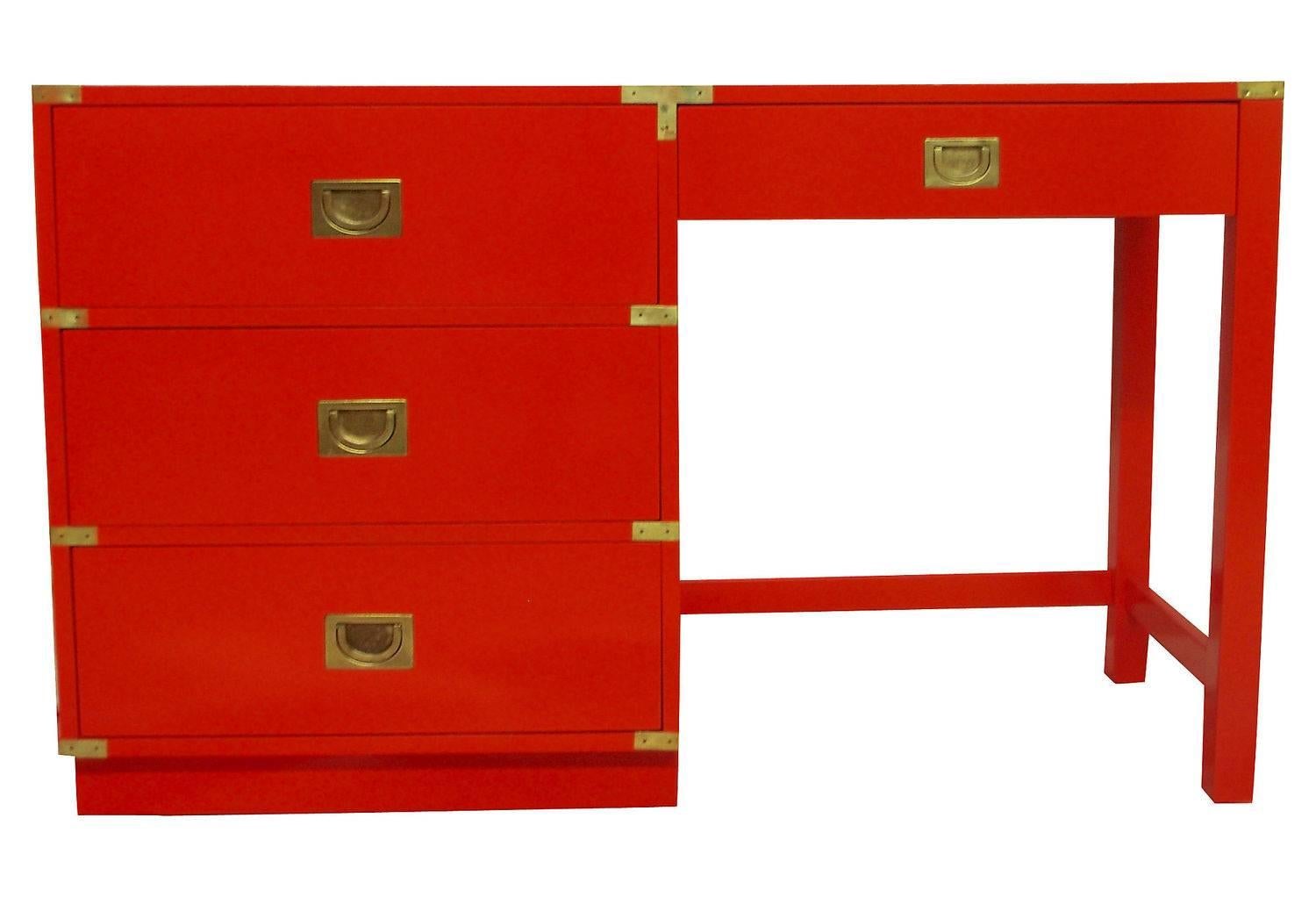 This is a beautiful high gloss fire engine red lacquer Campaign desk by Drexel Heritage. Featuring three drawers with brass pulls and corner details. Featuring dovetail constructed drawers, three storage drawers and one pencil drawer

 
