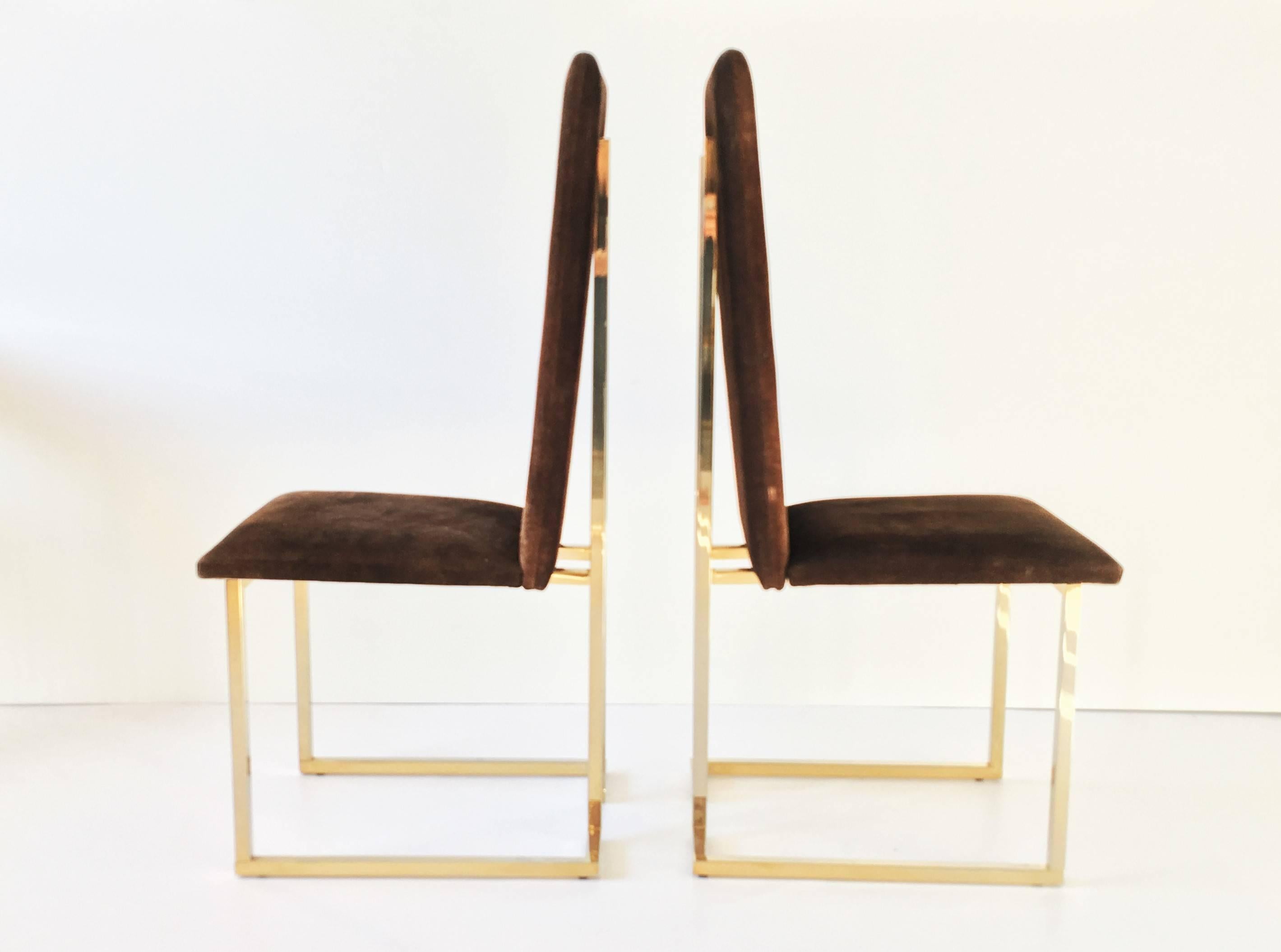 An exceptional pair of French, 1970s brass frame dining chairs. The frames are constructed of square brass tubing with brown suede seats and backs sitting on top of the frame. These are very comfortable, sculptural chairs that will make a lasting
