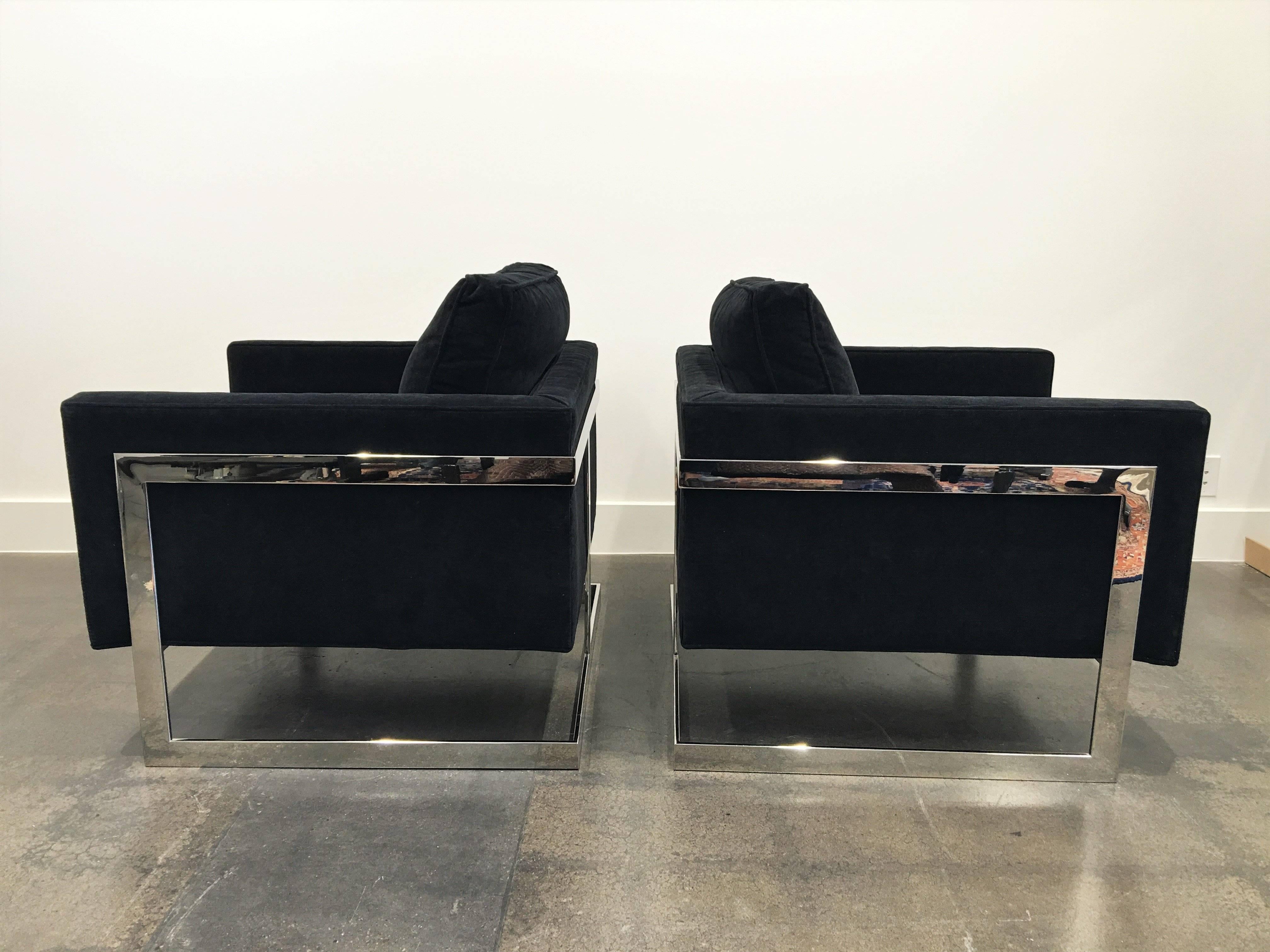 A pair of architectural lounge chairs by Milo Baughman for Thayer Coggin American, circa 1970. Rectilinear polished T-back steel frame supports an upholstered cube seat. These are the larger of the two that were made by Milo, hence wider and deeper