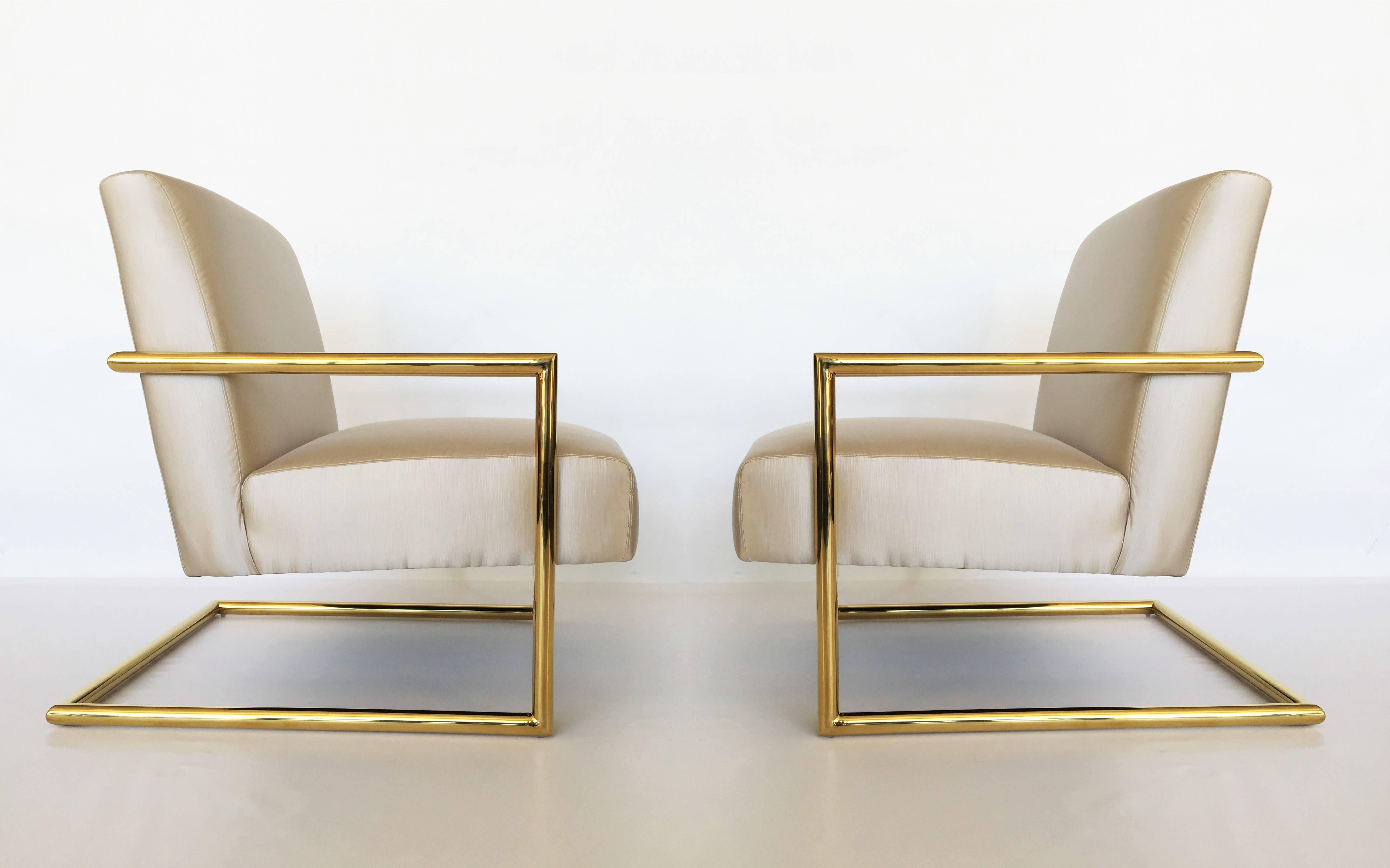 Great pair of cantilevered lounge chairs designed in the style of Milo Baughman for Thayer Coggin, American, 1970s. With frame in tubular polished brass and champagne silk upholstery. Simple yet elegant modern design. Very comfortable as having a