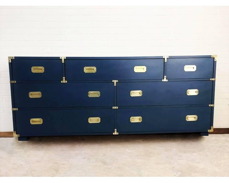 This attractive piece is crafted from solid walnut. Dresser is lacquered in blue and has decorative recessed hardware to the corners and recessed brass bail pulls. The chest has one large drawer and two small drawers to the top with four additional