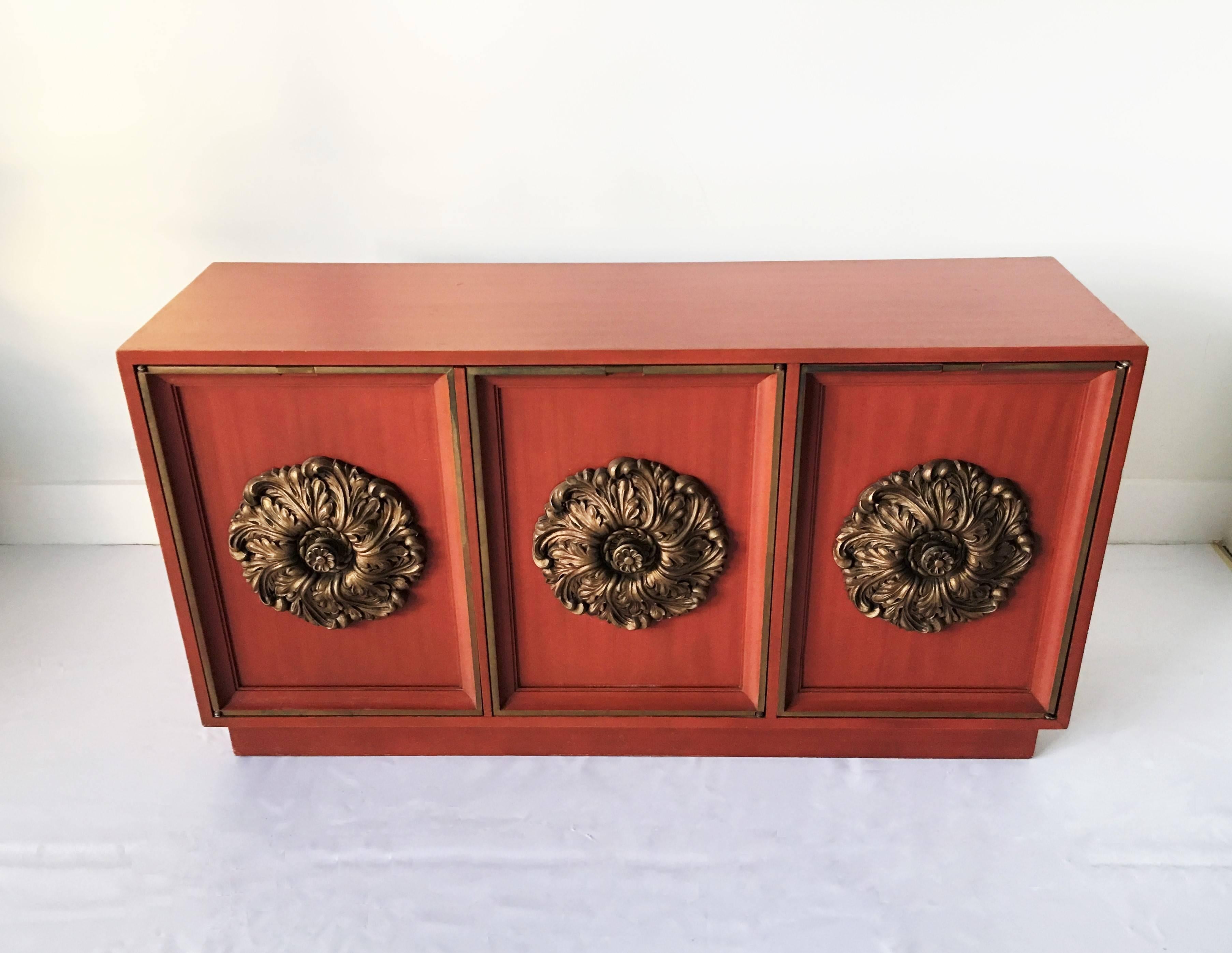 Absolutely stunning James Mont style credenza or buffet, with gilt medallions. Has three cabinet doors and the interior boasts a single shelf inside. An outstanding, incredibly chic piece in a very rare size.