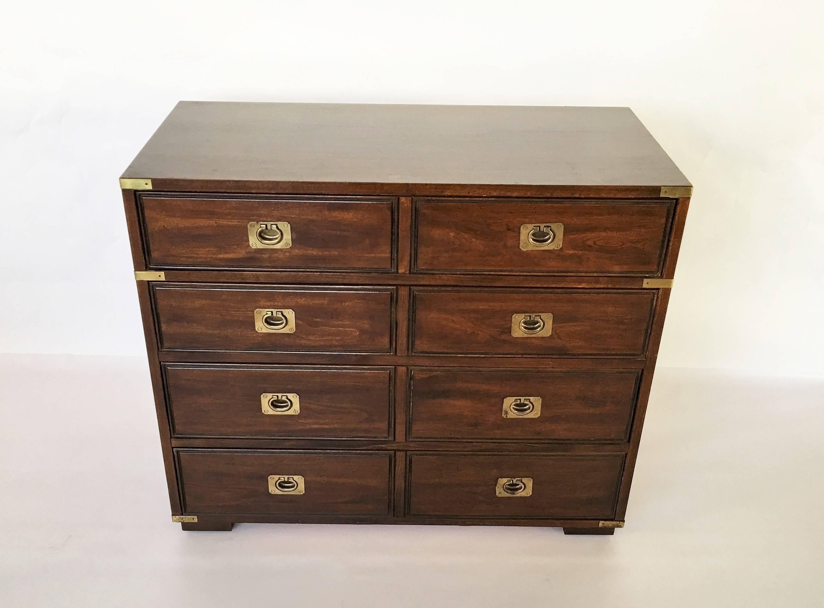 Vintage four-drawer Campaign style commode raised on square block feet by Thomasville. Brass corner guard detailing and brass recessed pulls.