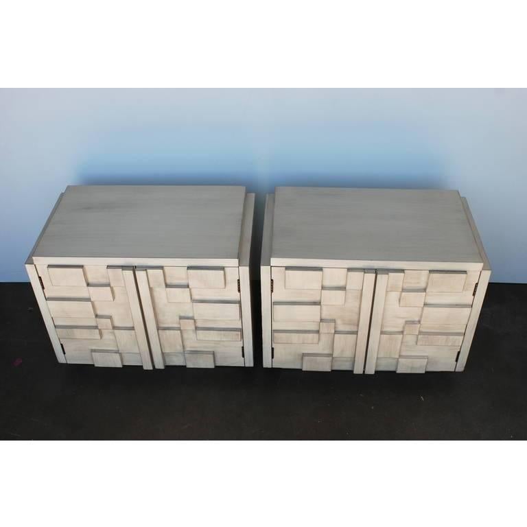 These cubist effect brutalist style nightstands refinished in a driftwood finish are manufactured by Lane. The Brutalist Styling on the block fronts is a reference to the Paul Evans Cityscape line.