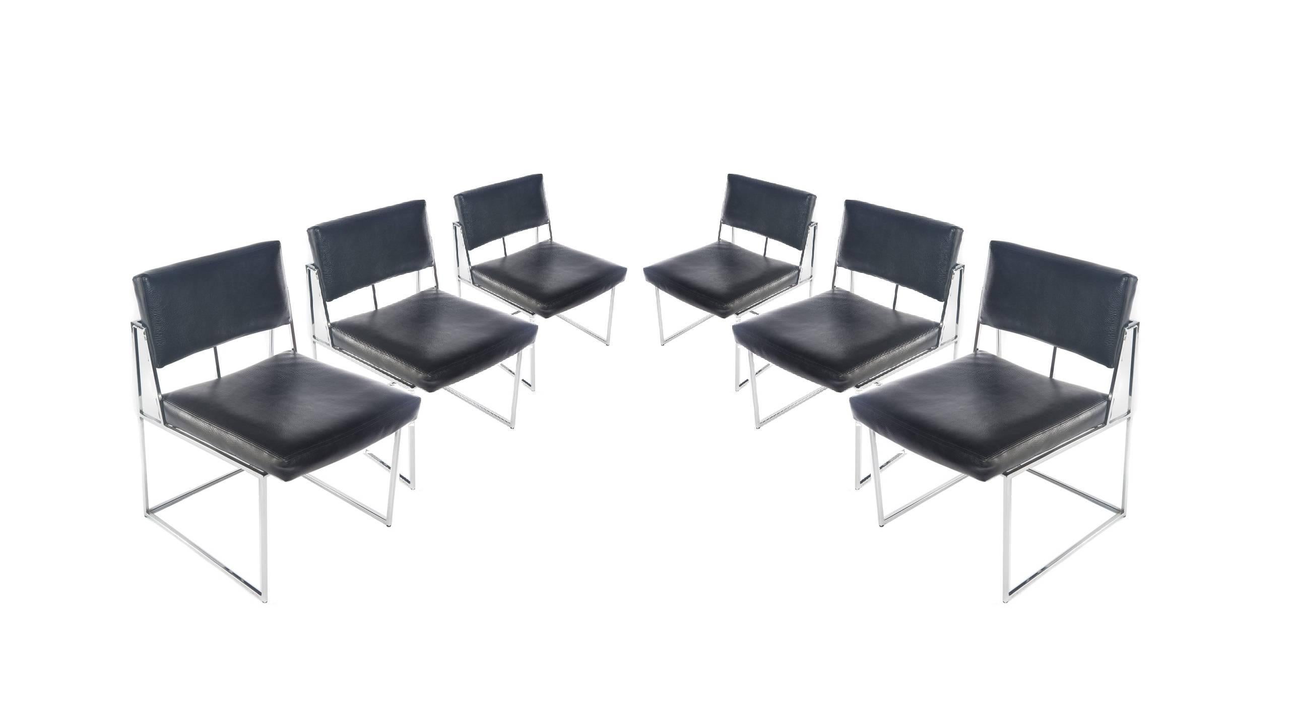 Set of eight dining chairs by Milo Baughman for Thayer Coggin. Model # 1188. Two armchairs features a straight crest rail and black vinyl upholstered back panel with padded armrests flanking a square seat. The chairs rise on polished thin line
