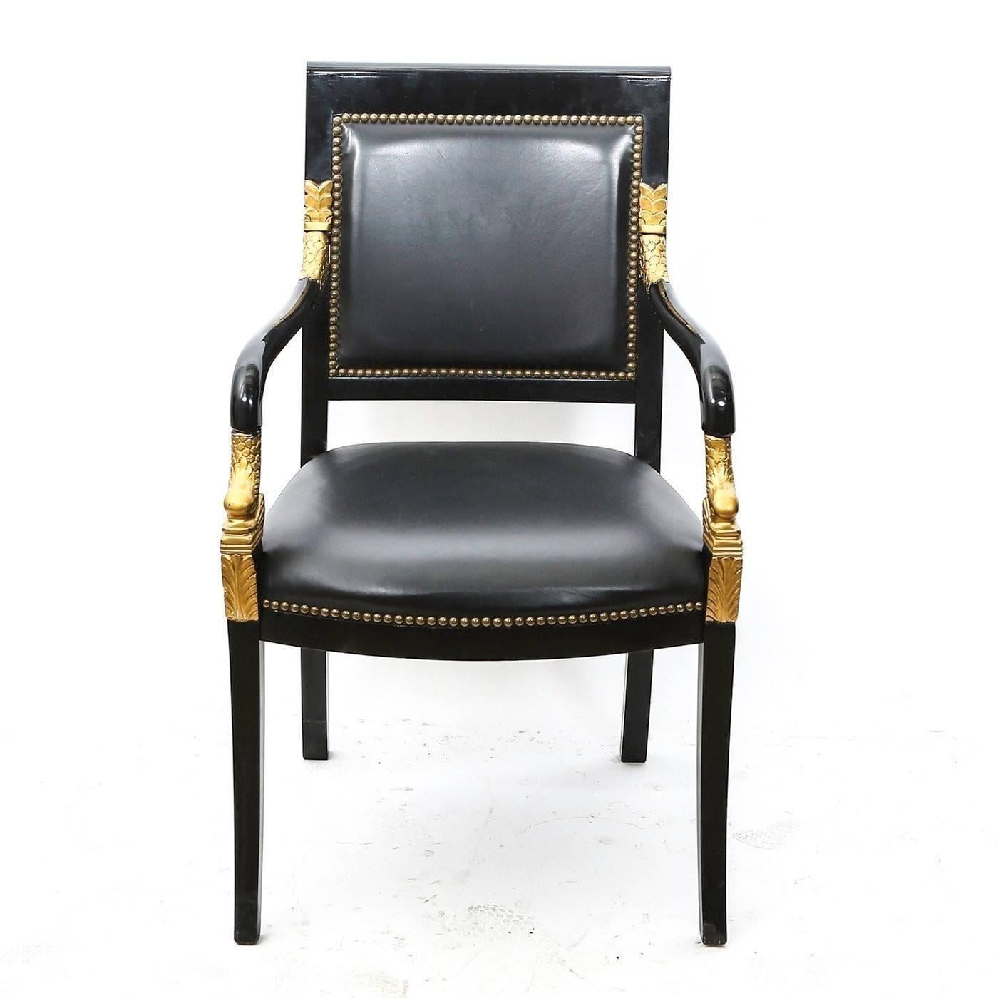 This lovely versatile set feature frames made of mahogany lacquered wood. Features an upholstered back with nailhead trim over an upholstered seat flanked by sloped arms with gilded carved dolphin form. Leather upholstery. The sabre front and back