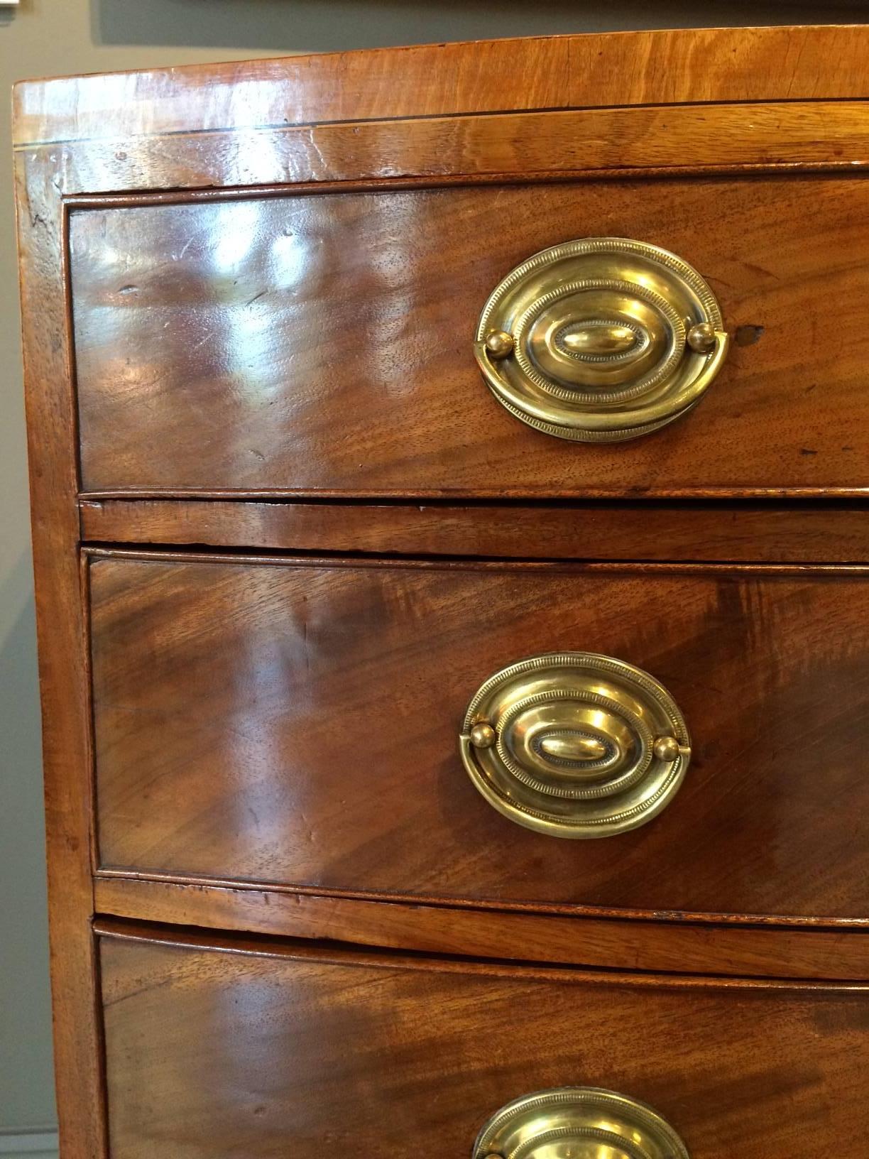 George III period mahogany bow fronted sideboard. Superb color and patin. Having a well figured top above four drawers standing elegantly on square tapered legs.