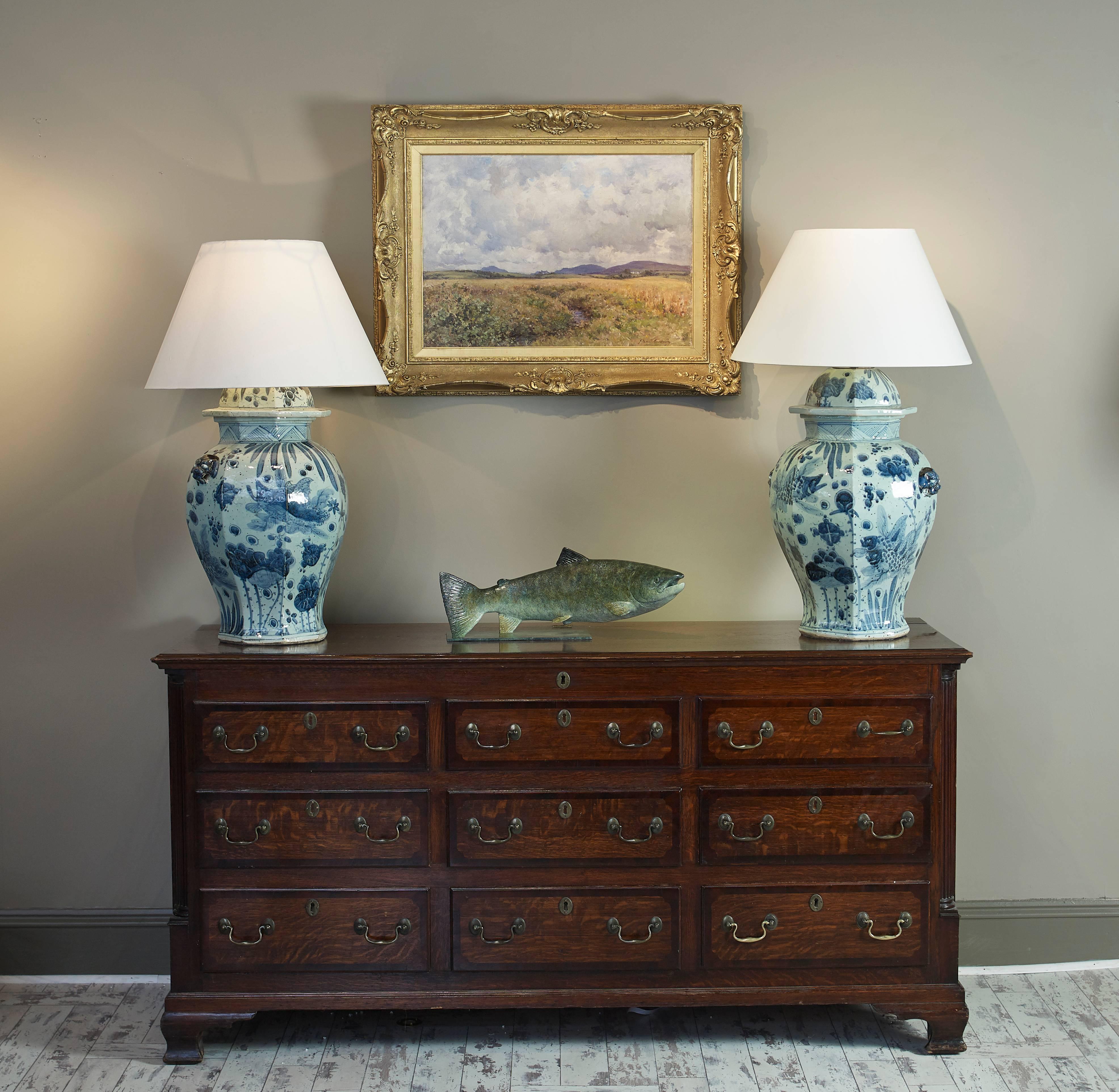 A stunning pair of Chinese blue and white ginger jar lamps of unusually large size and superb colour. Decorated ornately with fish, flowers and animals.