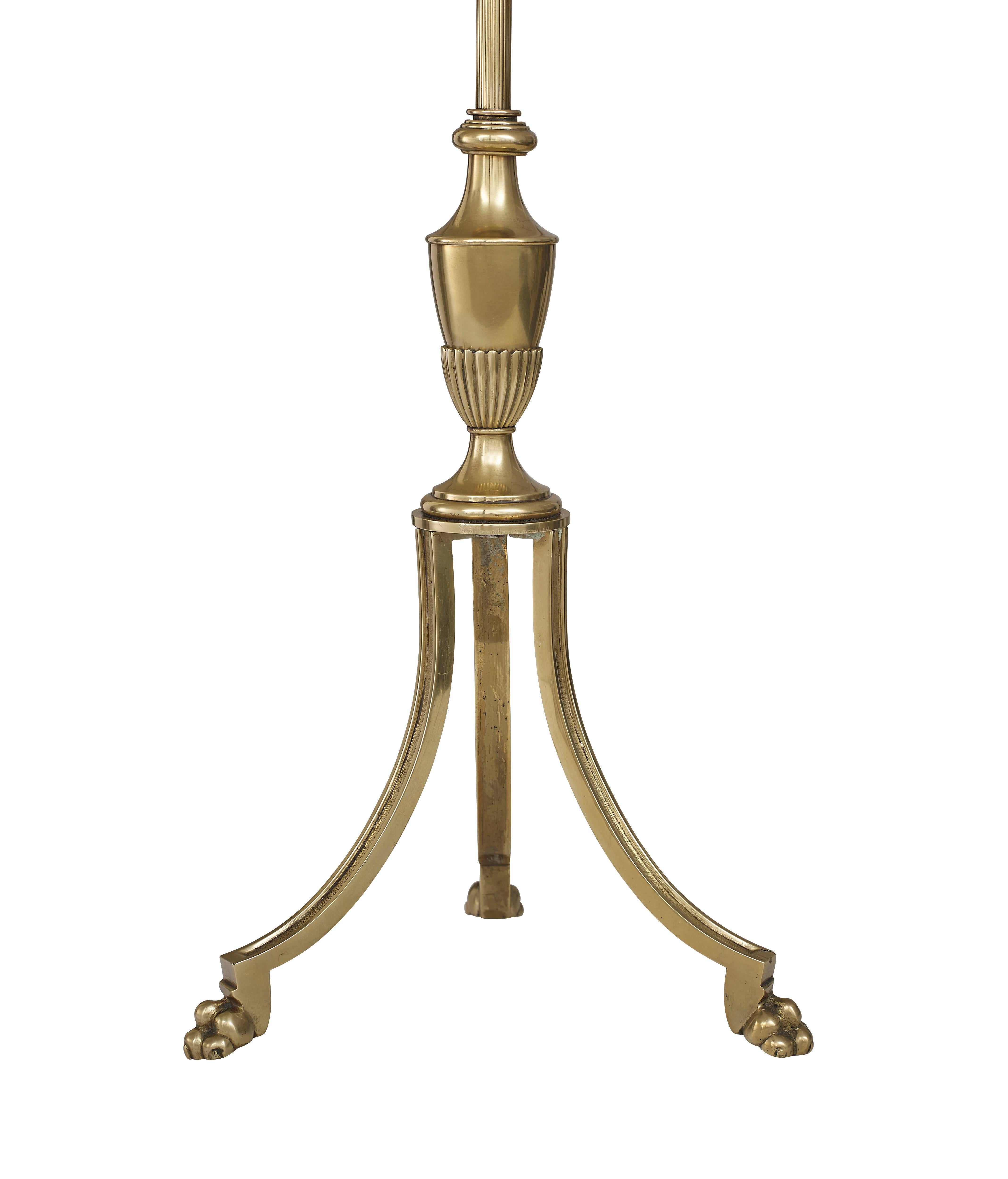 A beautiful Maison Jansen floor lamp with a claw feet base and stunning above. A brass column leading to a large waxed candelabra attached to a three bulb fitting, which are all adjustable.

A handmade french black and lined gold lampshade is