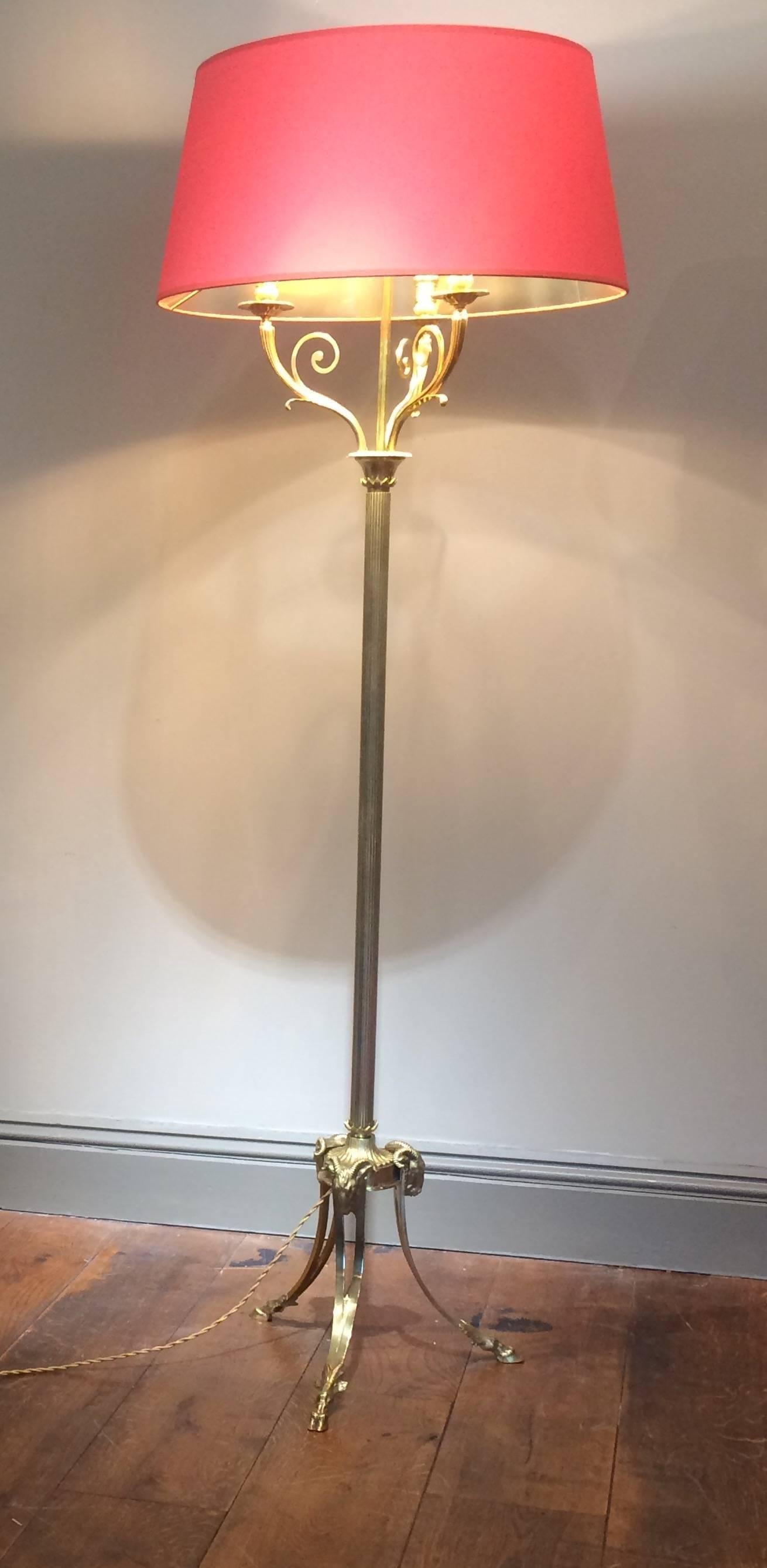 A beautiful signed Marcel Guillemard bronze and brass floor lamp. Lovely detailed ram's head at the base with rams feet on the bottom. Heavy fluted column leading to a three head scrolling candelabra. 

Handmade French orange and lined gold