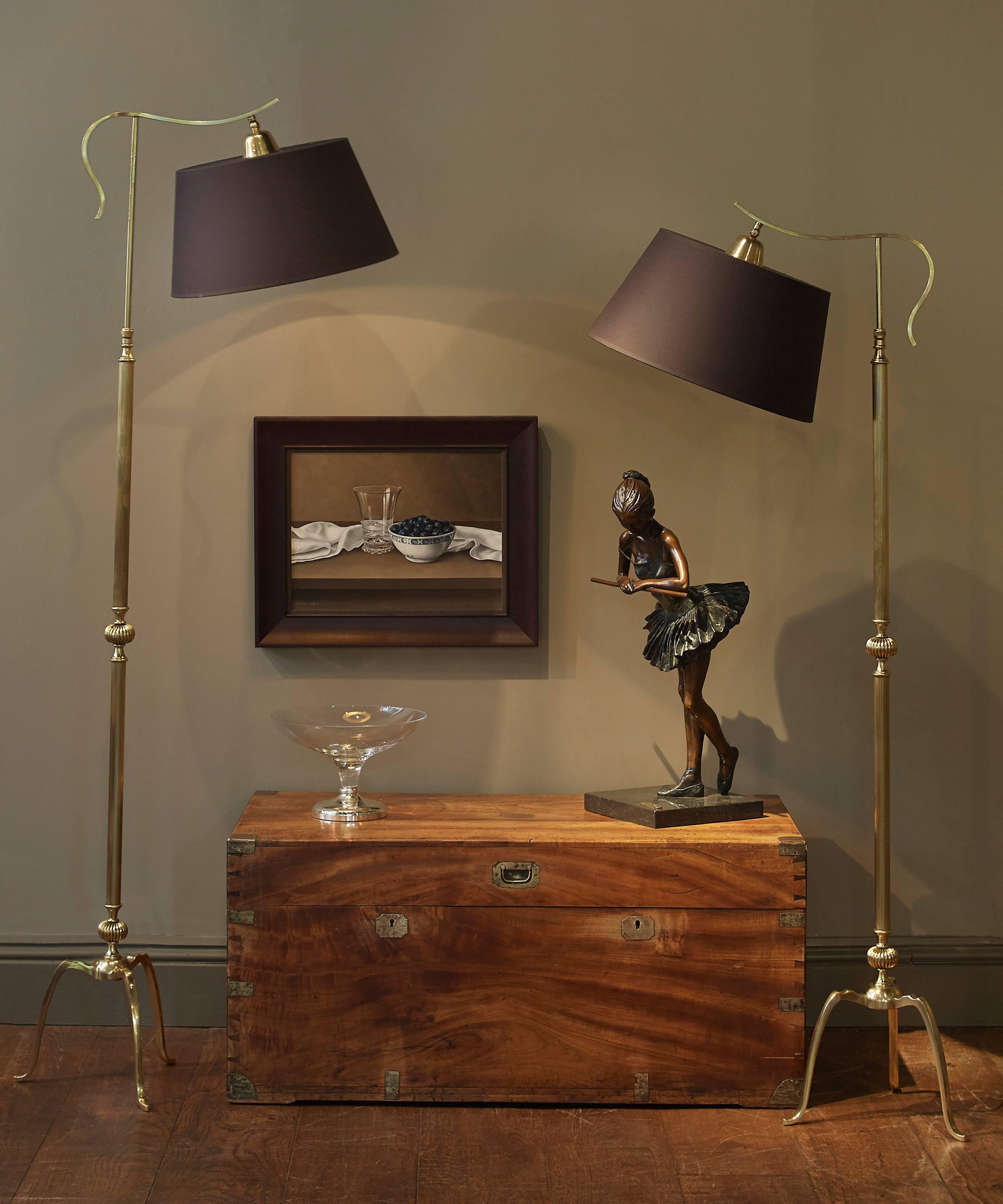 A stunning pair of adjustable brass reading lamps. Heavy brass fluted metal work with lovely detail on the top of the base. 

Each lamp is adjustable in height 68inches at their tallest and 53inches at their shortest. The bulbs also adjust
