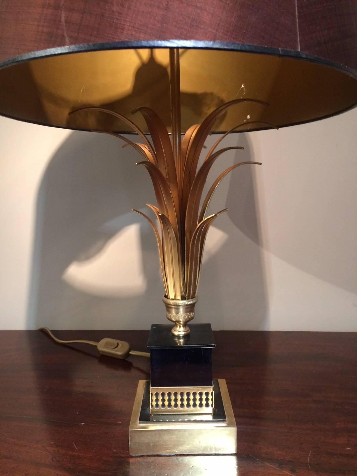 A exquisite gold pineapple lamp with black base. In the style of the designer Maison Charles. Lovely detail on the pineapple leaves. Three bulb fixture which allows for brilliant light.

Burgundy lampshade included in the price.

Wired and ready