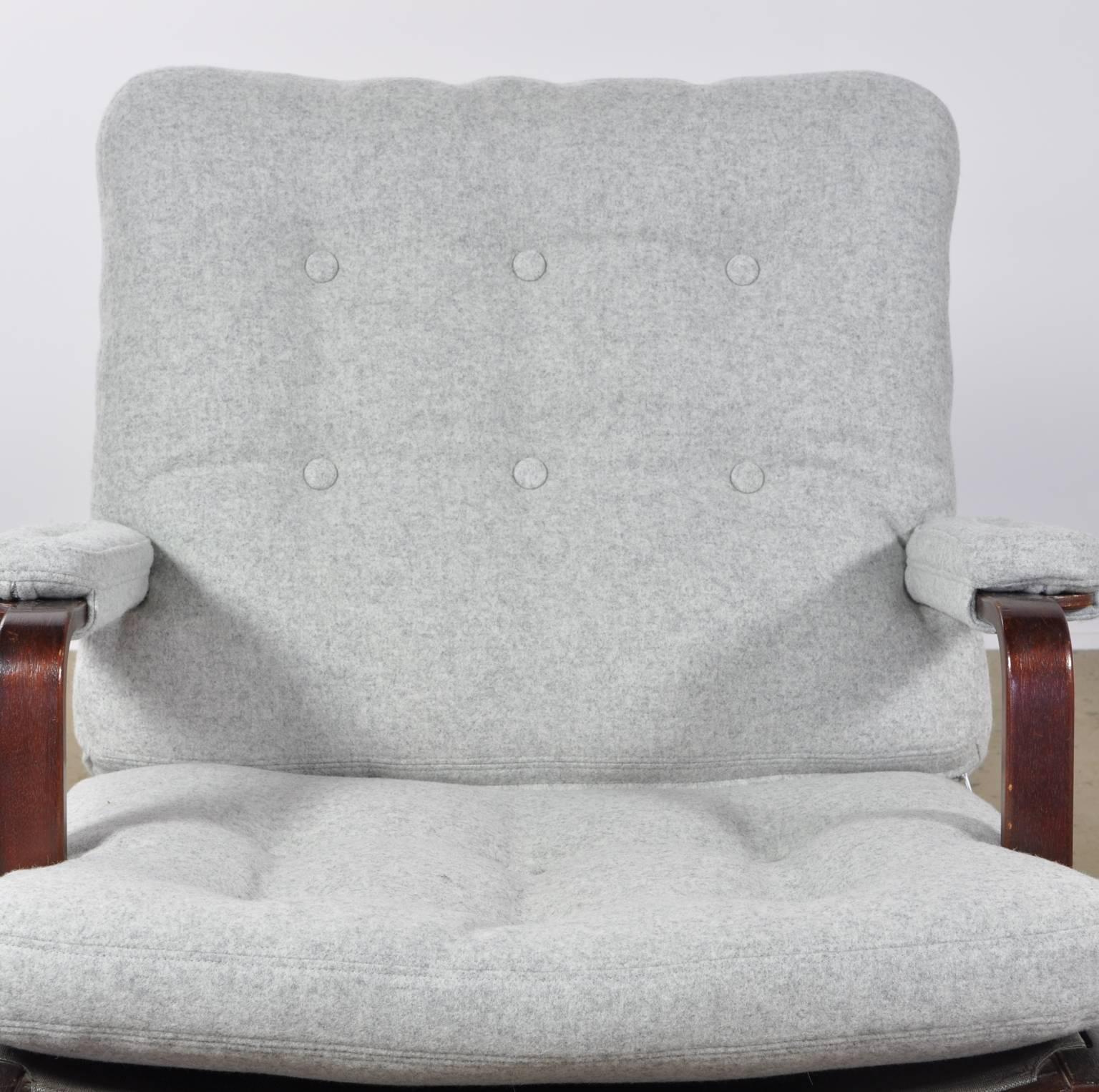 Fully restored example of the Classic Ingrid chair. This original DUX stamped item has been reupholstered in a Maharam Divina grey woolen felt fabric.

A sturdy wide design. The Ingrid uses a angled bentwood frame and deep generous seat pitch.
 