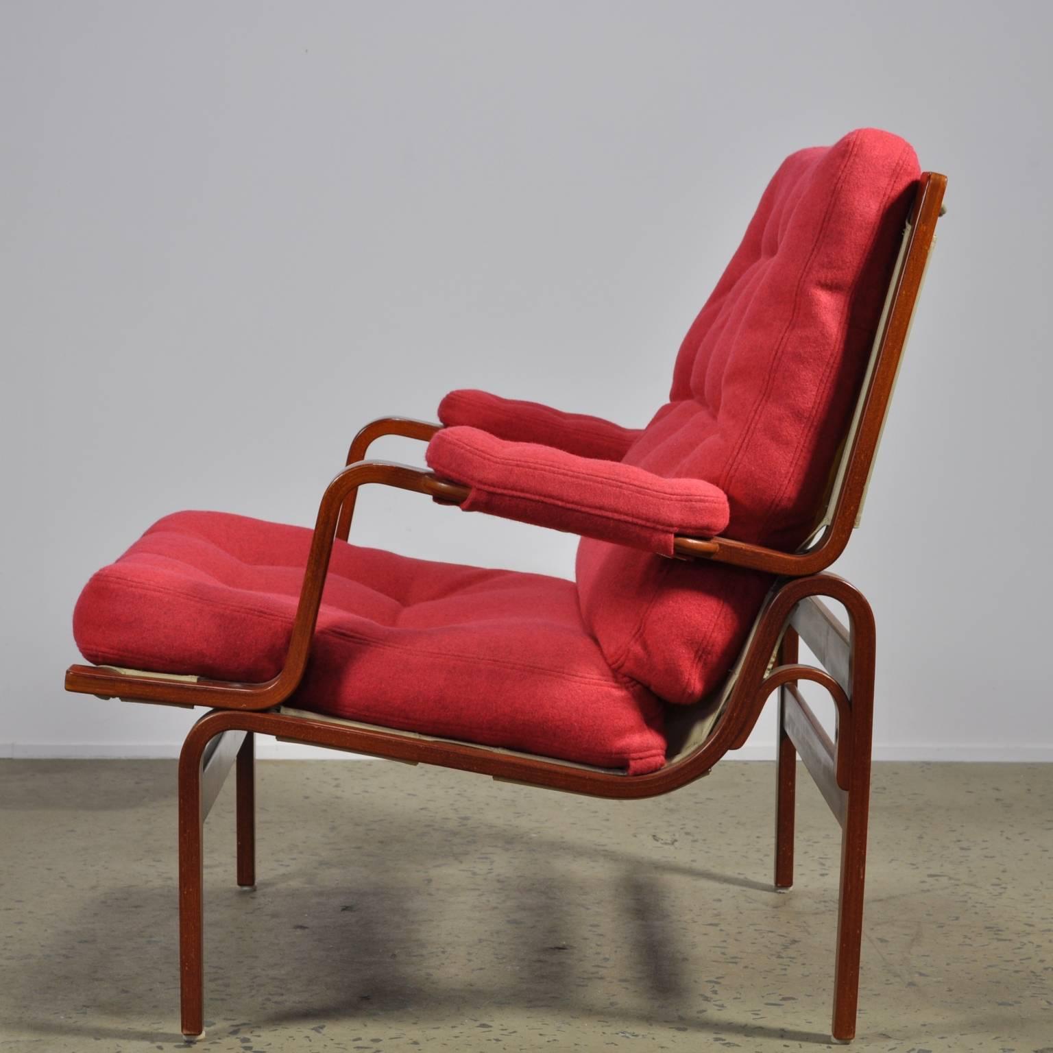 Fully restored example of the Classic Ingrid chair. This original DUX stamped item has been reupholstered in red Maharam Divina melange 531 felt fabric.

A sturdy wide design. The ingrid uses a angled bentwood frame and deep generous seat