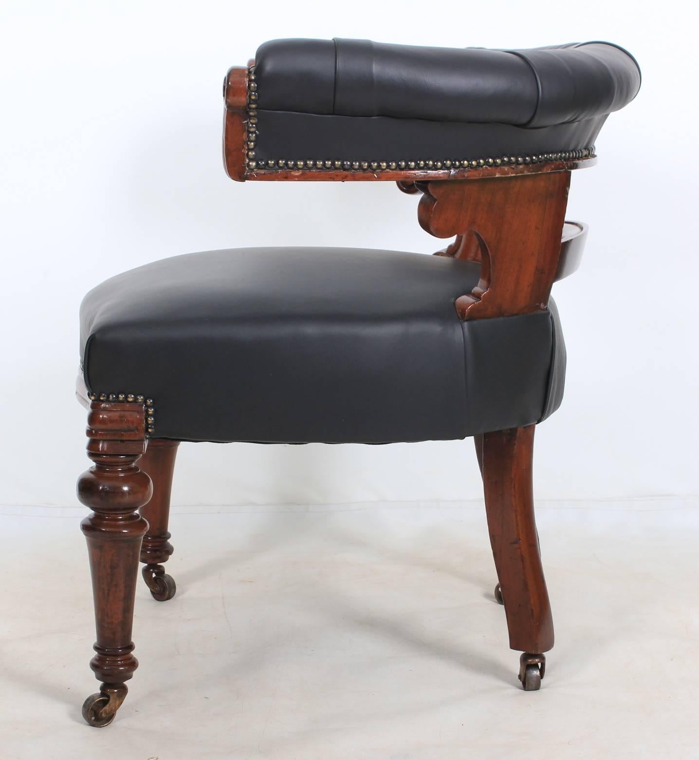 English, circa 1840.
A heavy mahogany and leather desk chair in showroom condition.
Lovely horse shoe back upholstered in a black leather with carved scroll arms and carved back support.
Comfortable black leather seat.
On turned legs with brass