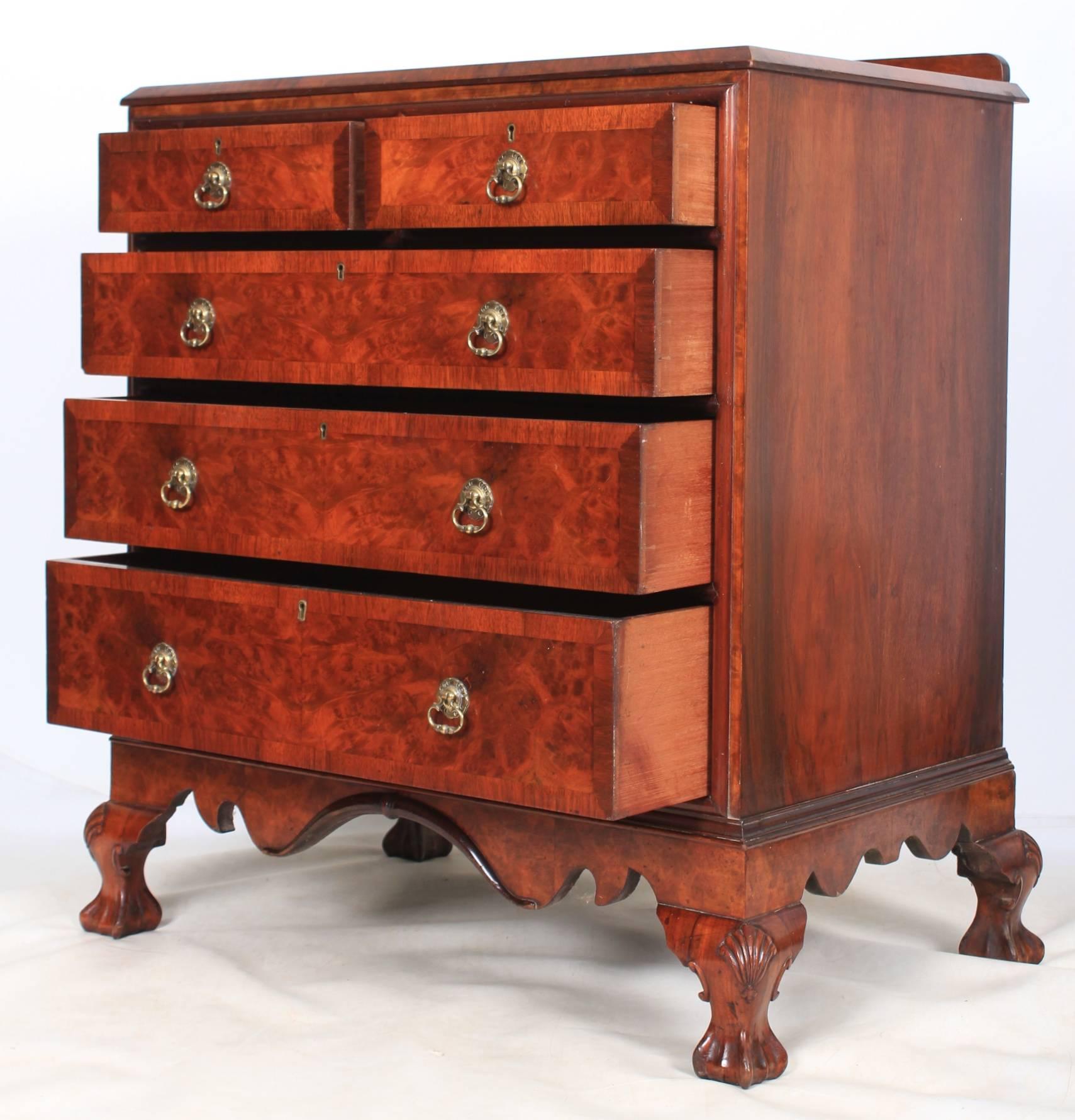 English, circa 1920.
This burr walnut chest is in superb condition.
A beautiful colour burr walnut top over two small and three long graduated drawers.
The drawers are of solid mahogany dovetailed construction, with crossbanded fronts and brass