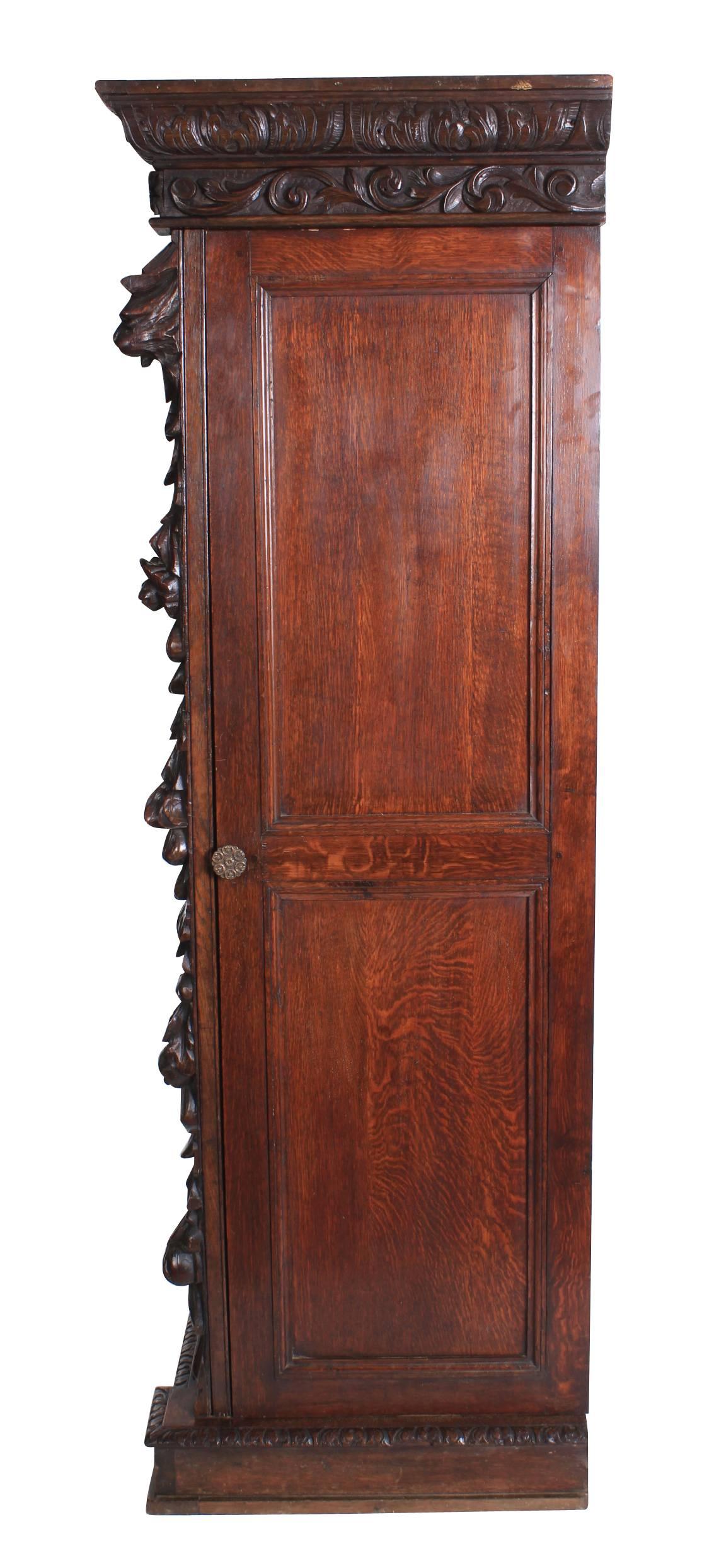 English, circa 1880.
An impressive hall cupboard in great condition.
Profusely carved cornice which can be removed for easy transport, and a beautiful carved front showing decorative foliage and a central mask.
There are doors either side which